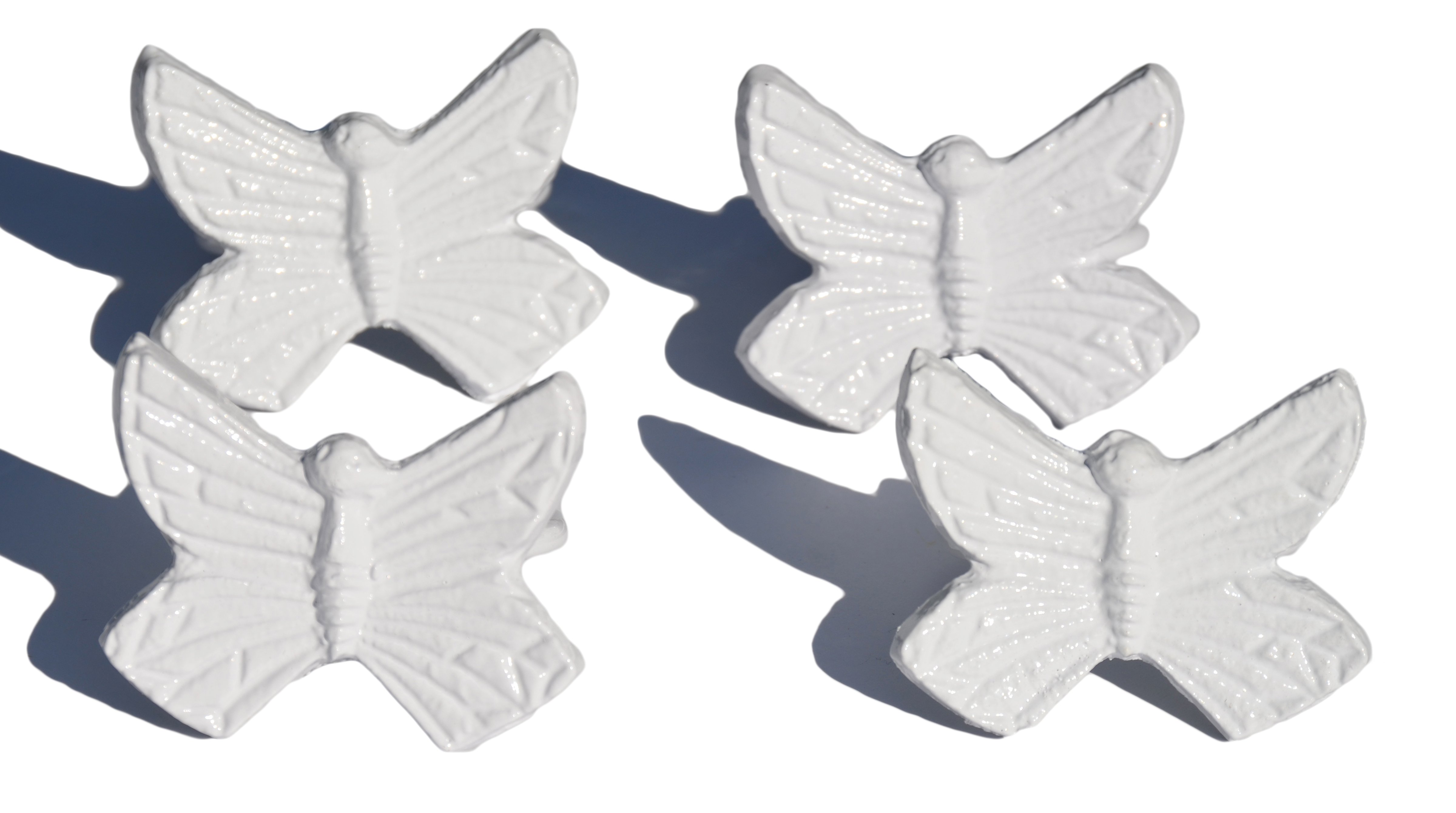 Set of 4 handcrafted aluminum butterfly napkin rings, elegantly designed for upscale dining decor.