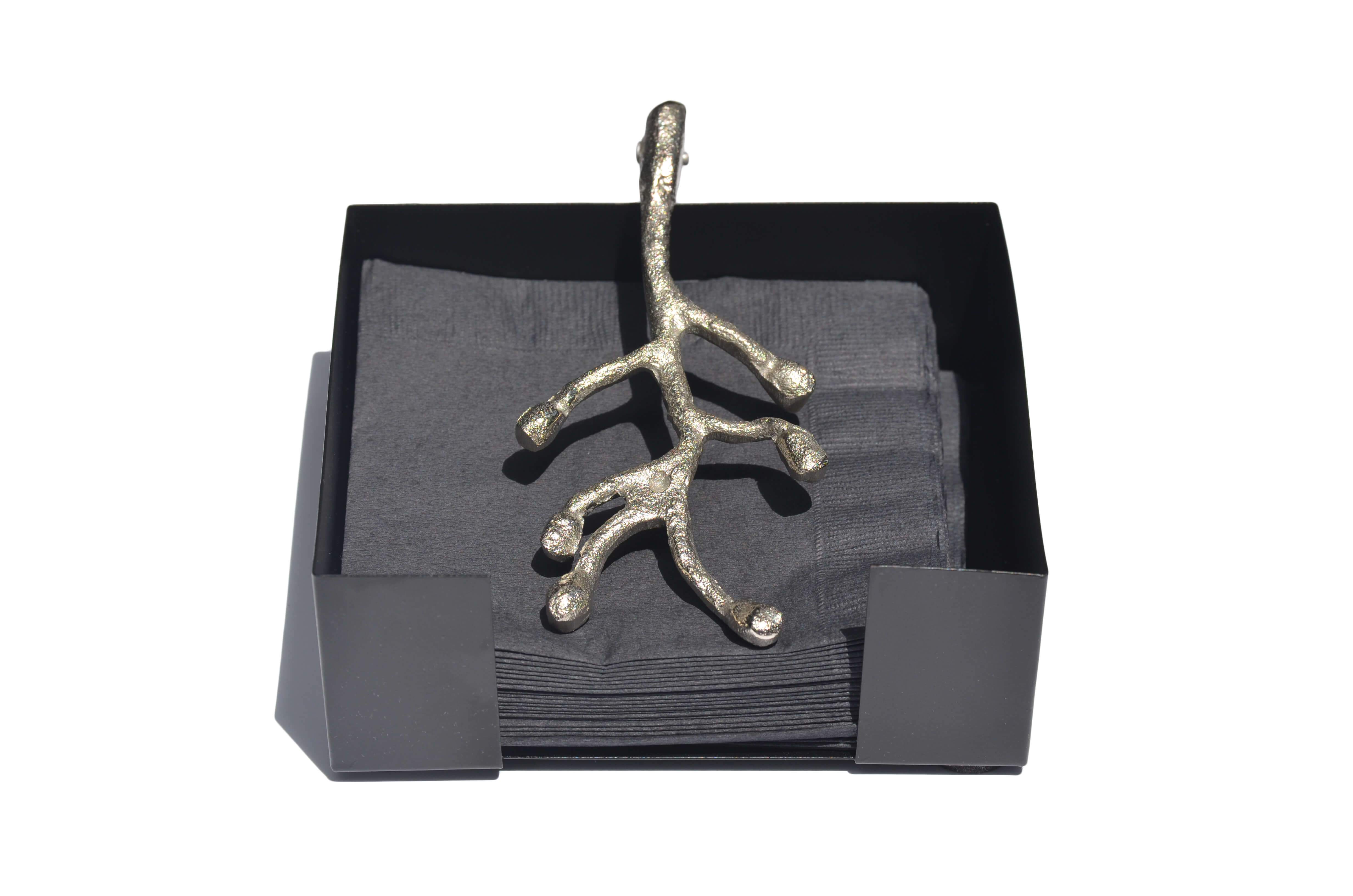 Vibhsa handcrafted silver napkin holder with antique flower bud design, elegantly displayed on a dining table.