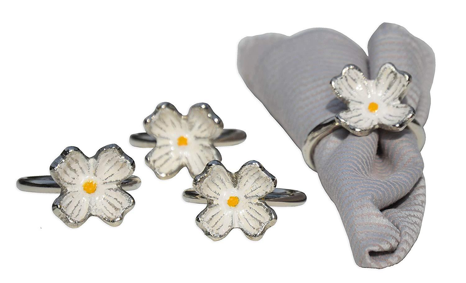 Set of 4 handcrafted silver floral napkin rings made from aluminum, featuring intricate flower designs for elegant table settings.