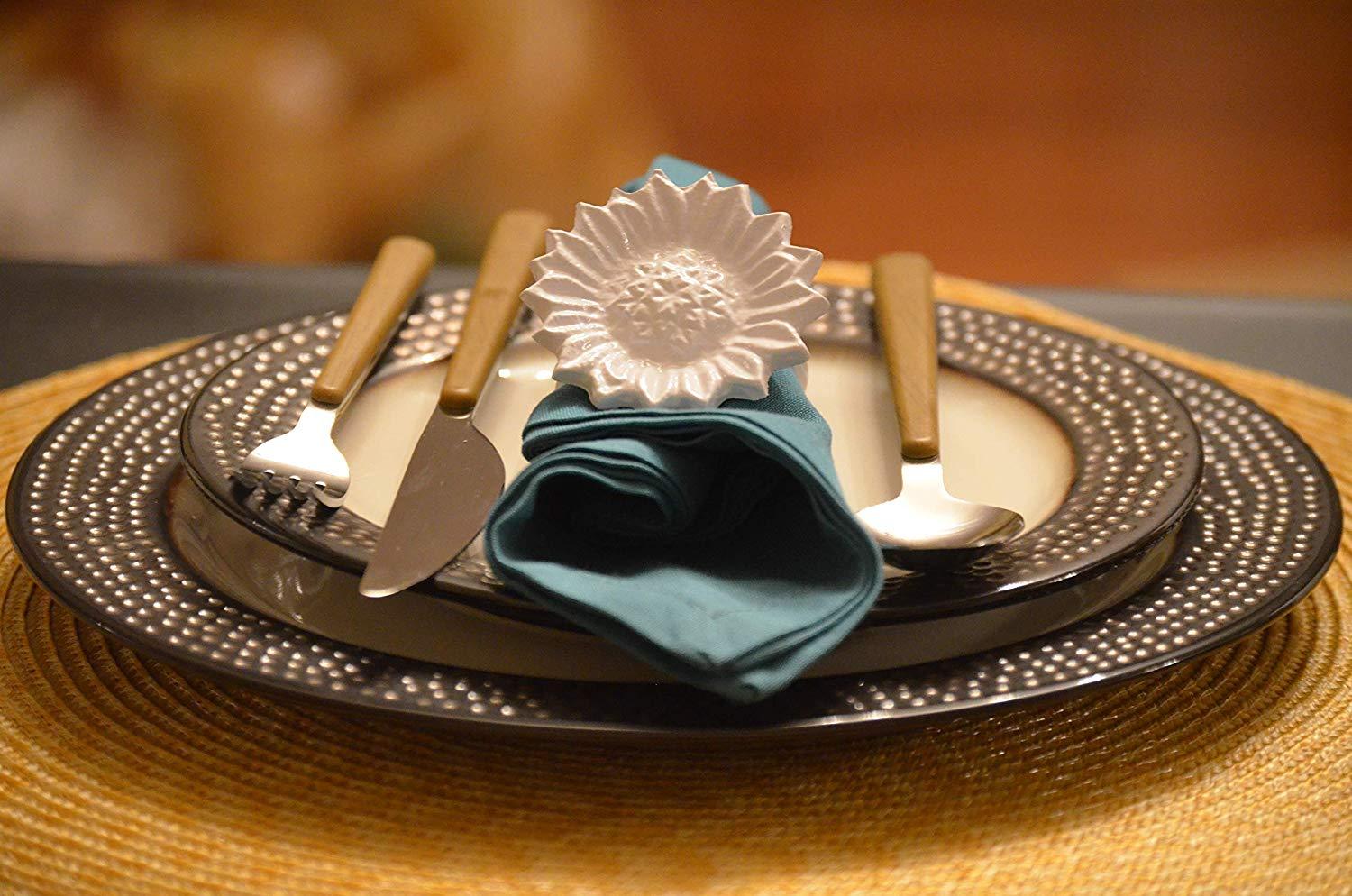 Set of 4 handcrafted white aluminum sunflower napkin rings, elegantly designed for dining decor.