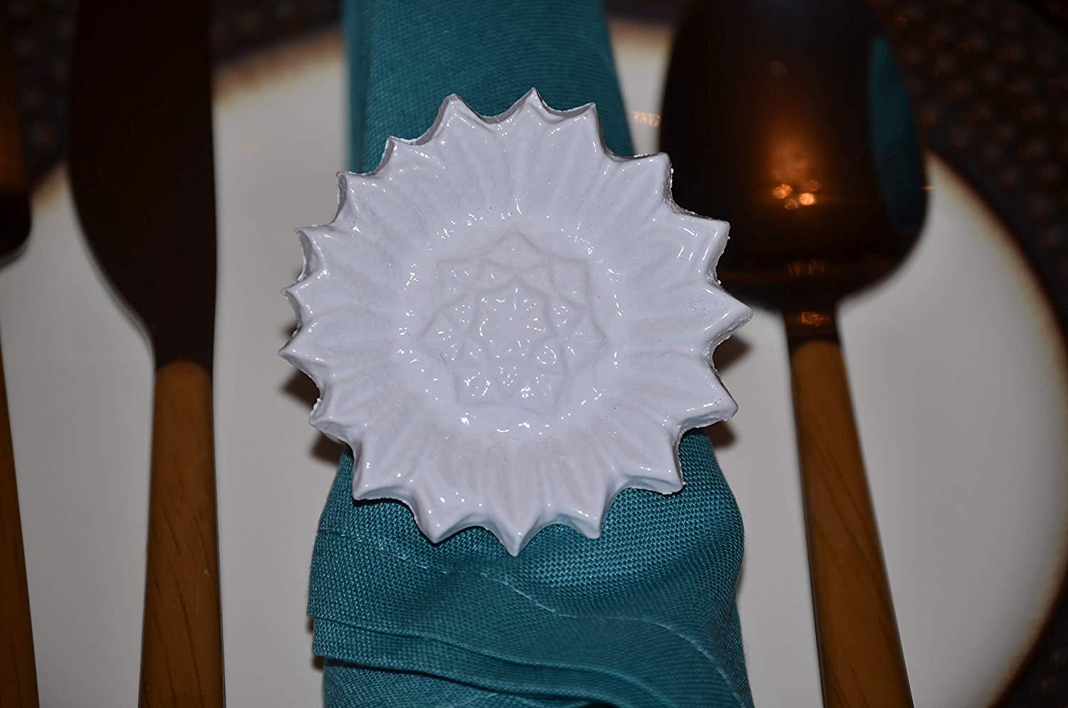 Set of 4 handcrafted white aluminum sunflower napkin rings, elegantly designed for dining decor.