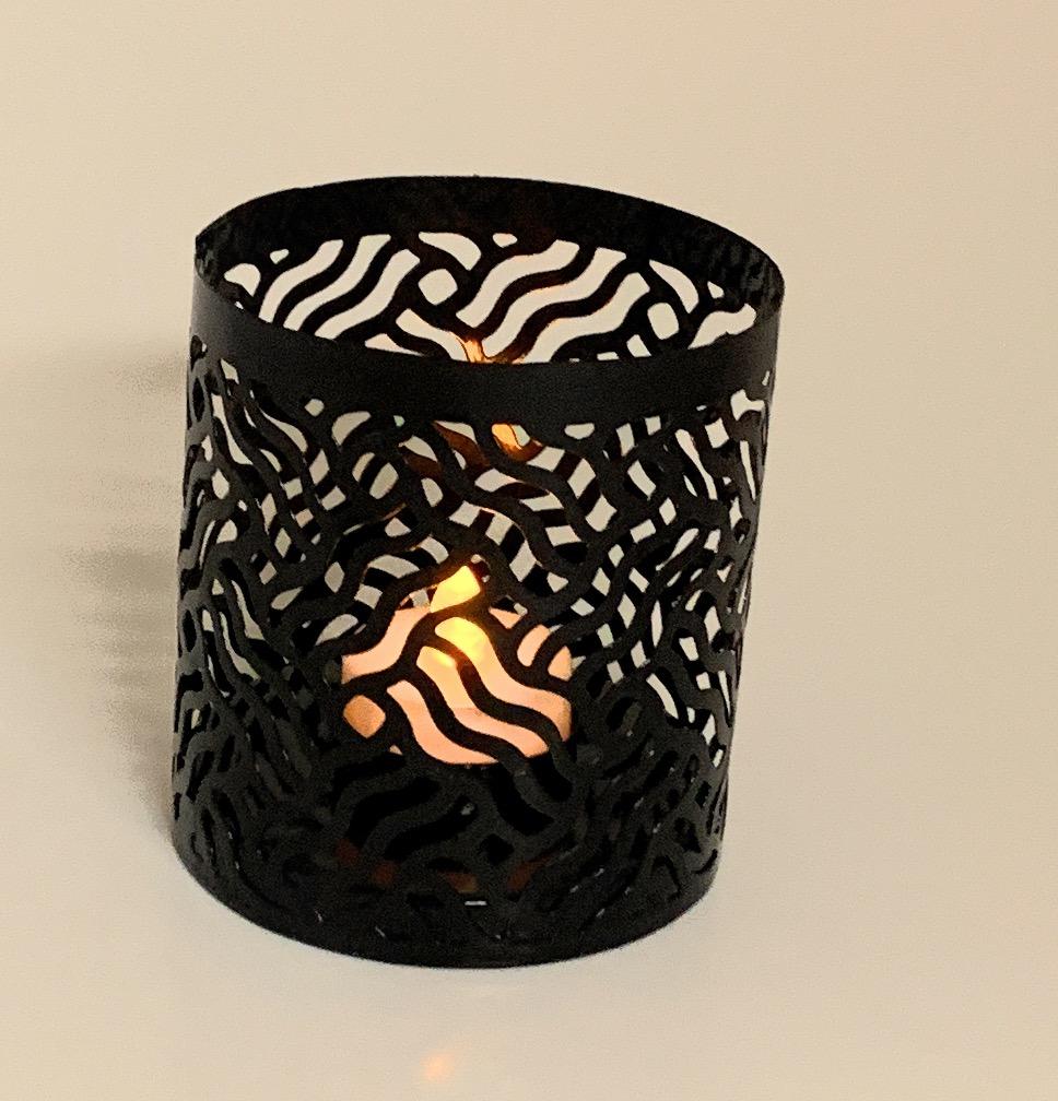 Set of 3 Vibhsa votive candle holders in Black, Grey, and Golden with intricate laser-cut designs, perfect for creating a cozy atmosphere.