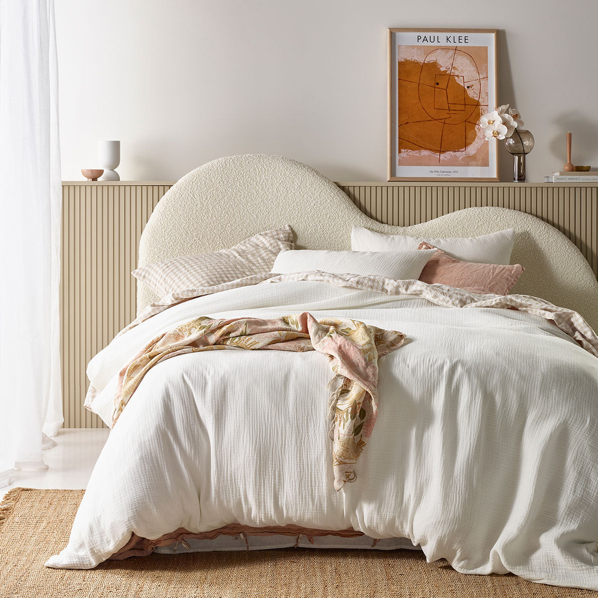 Hugo White Cotton Gauze Quilt Cover Set displayed on a queen-sized bed, showcasing its soft texture and elegant solid colour design.