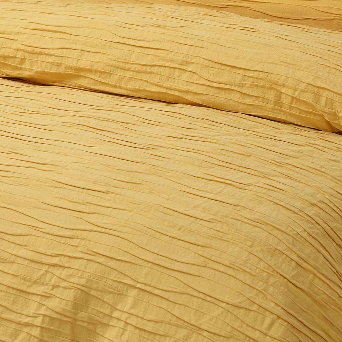 Malvern Ochre Cotton Quilt Cover Set featuring horizontal pleats, perfect for a queen-sized bed.