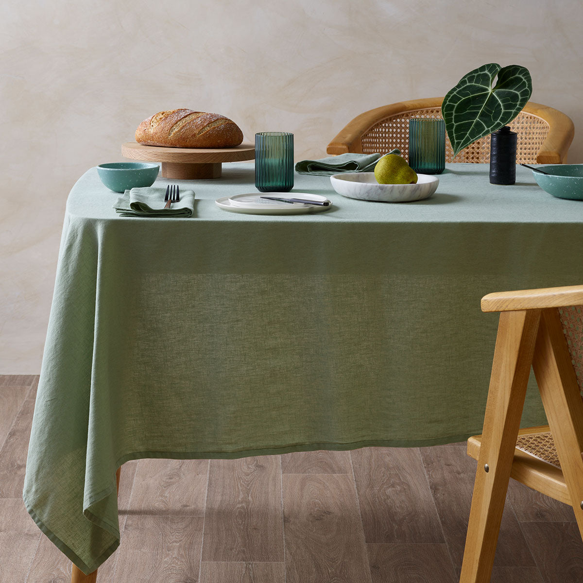 Sage Vintage Washed Linen Cotton Tablecloth elegantly draped over a dining table, showcasing its soft neutral tones and minimalist design.