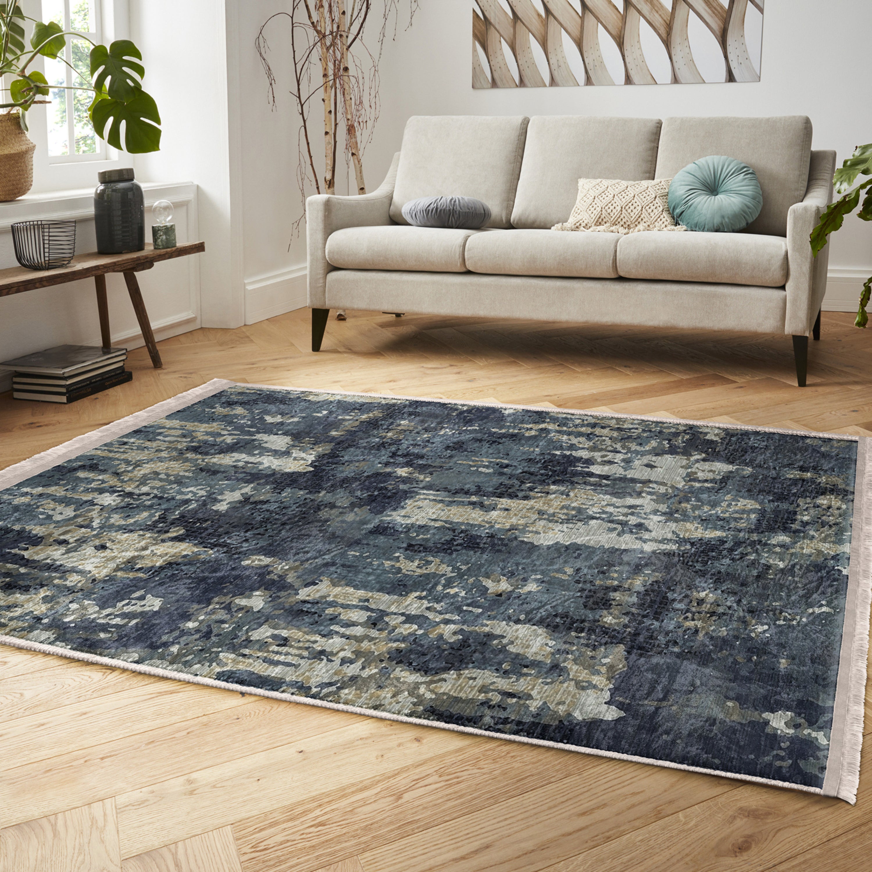 A vintage style washable area rug featuring elegant patterns and fringes, perfect for home decor.