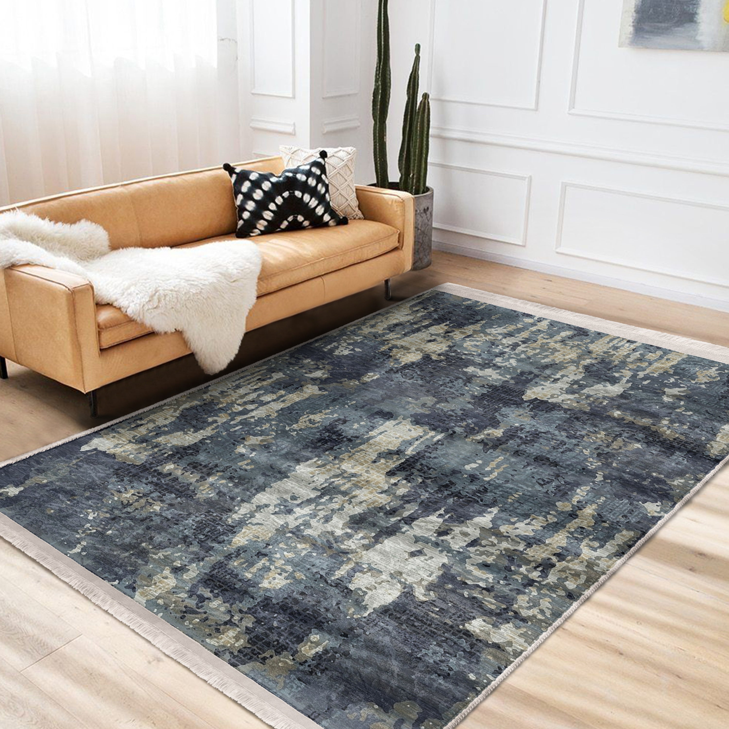 A vintage style washable area rug featuring elegant patterns and fringes, perfect for home decor.