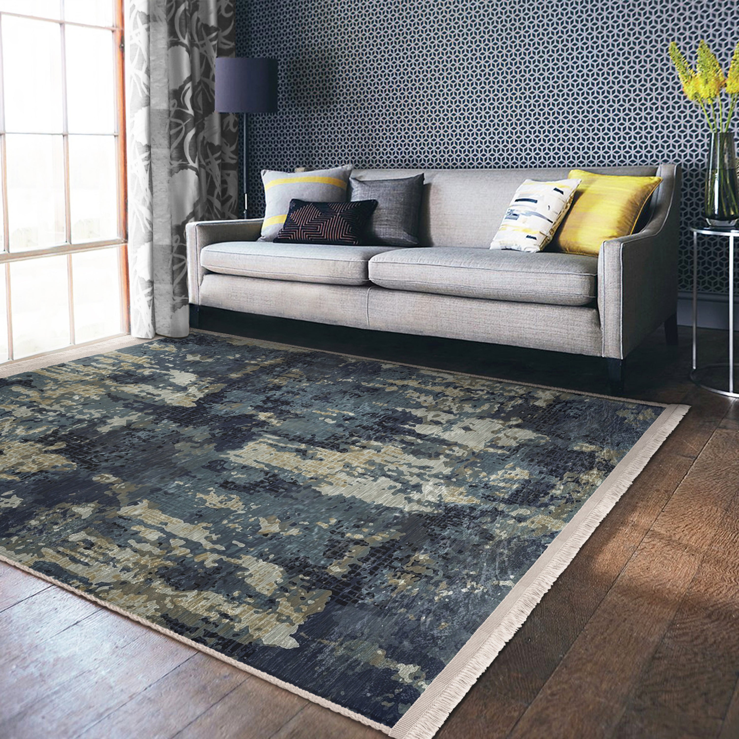 A vintage style washable area rug featuring elegant patterns and fringes, perfect for home decor.