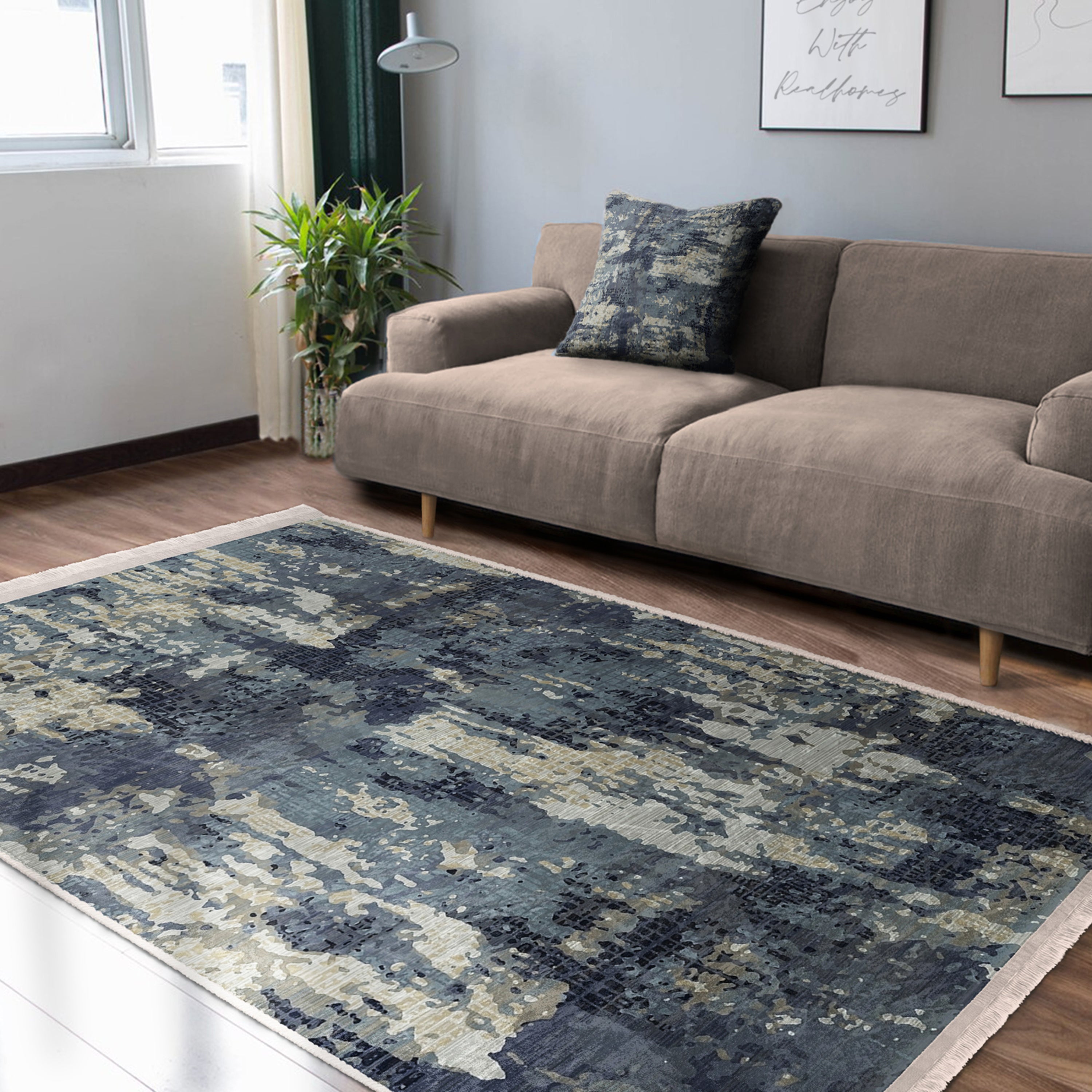 A vintage style washable area rug featuring elegant patterns and fringes, perfect for home decor.