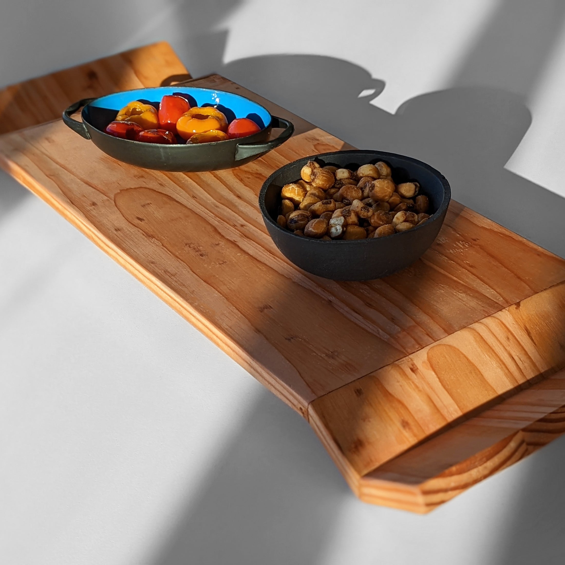 W Tray made of Doug Fir wood with beeswax finish, elegantly designed for serving food.