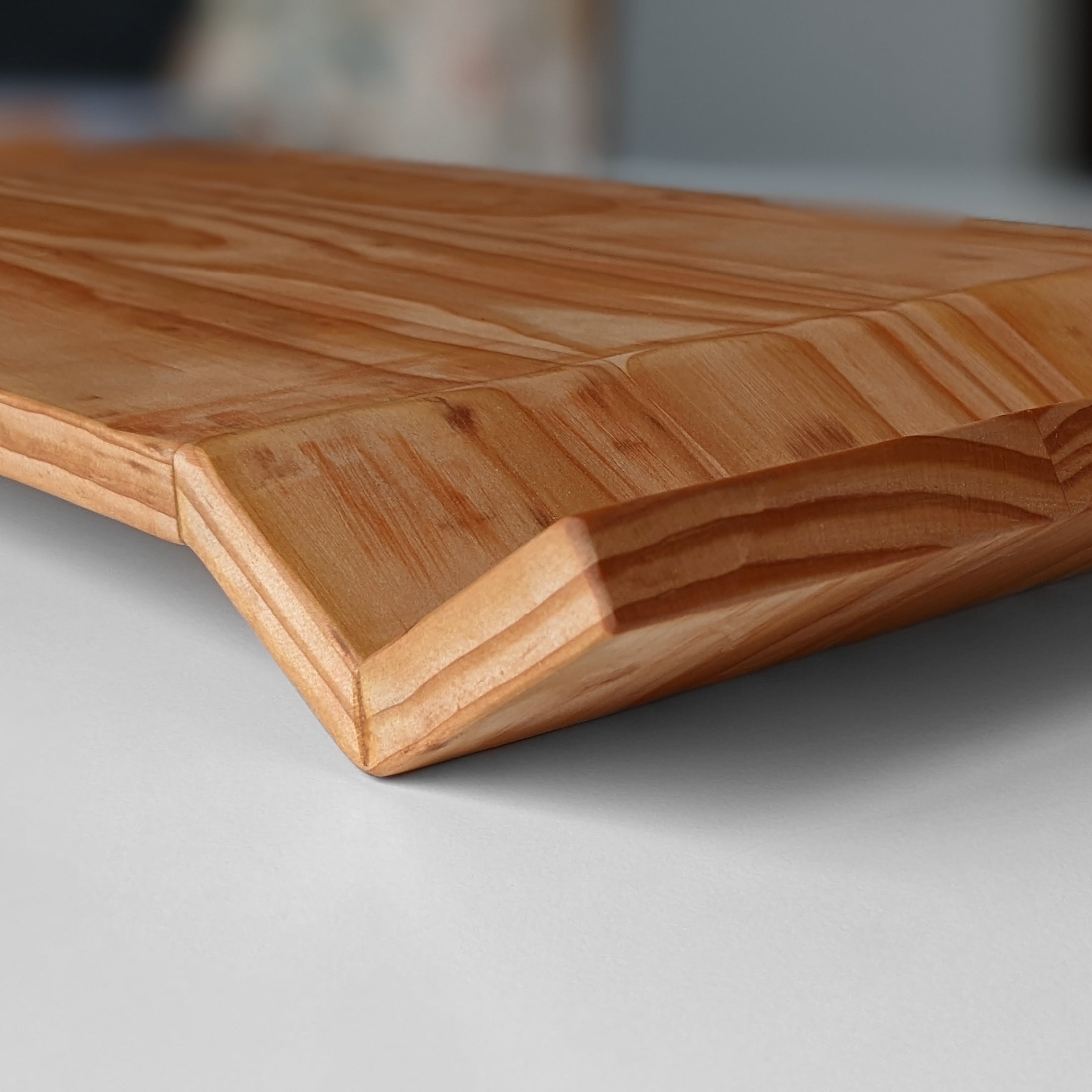 W Tray made of Doug Fir wood with beeswax finish, elegantly designed for serving food.