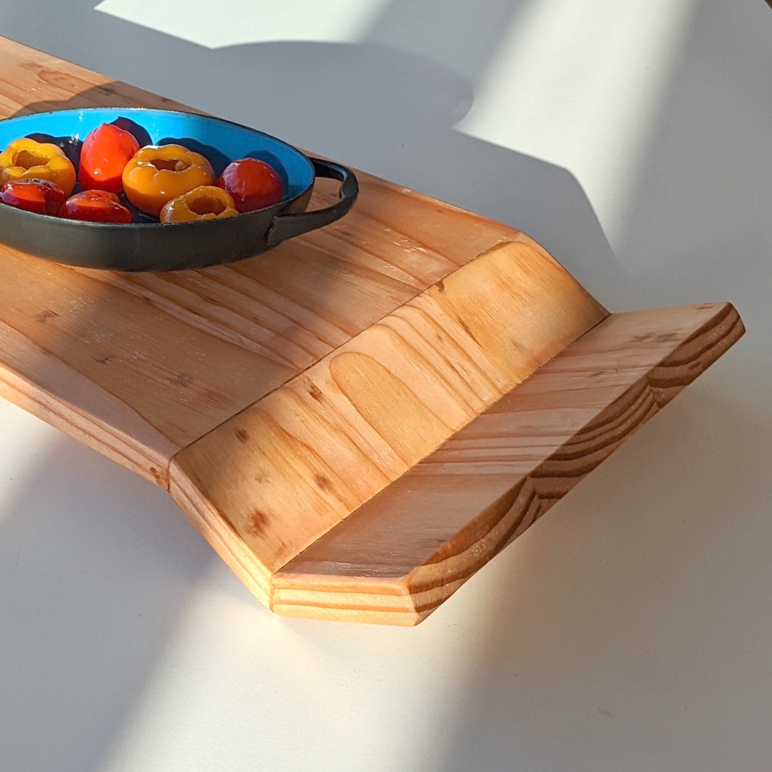 W Tray made of Doug Fir wood with beeswax finish, elegantly designed for serving food.