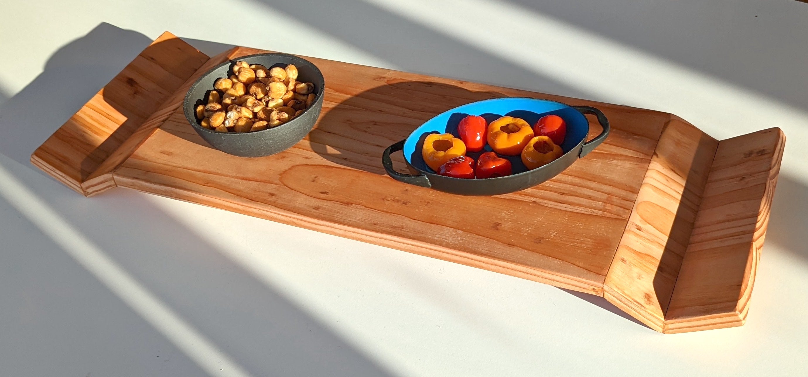 W Tray made of Doug Fir wood with beeswax finish, elegantly designed for serving food.