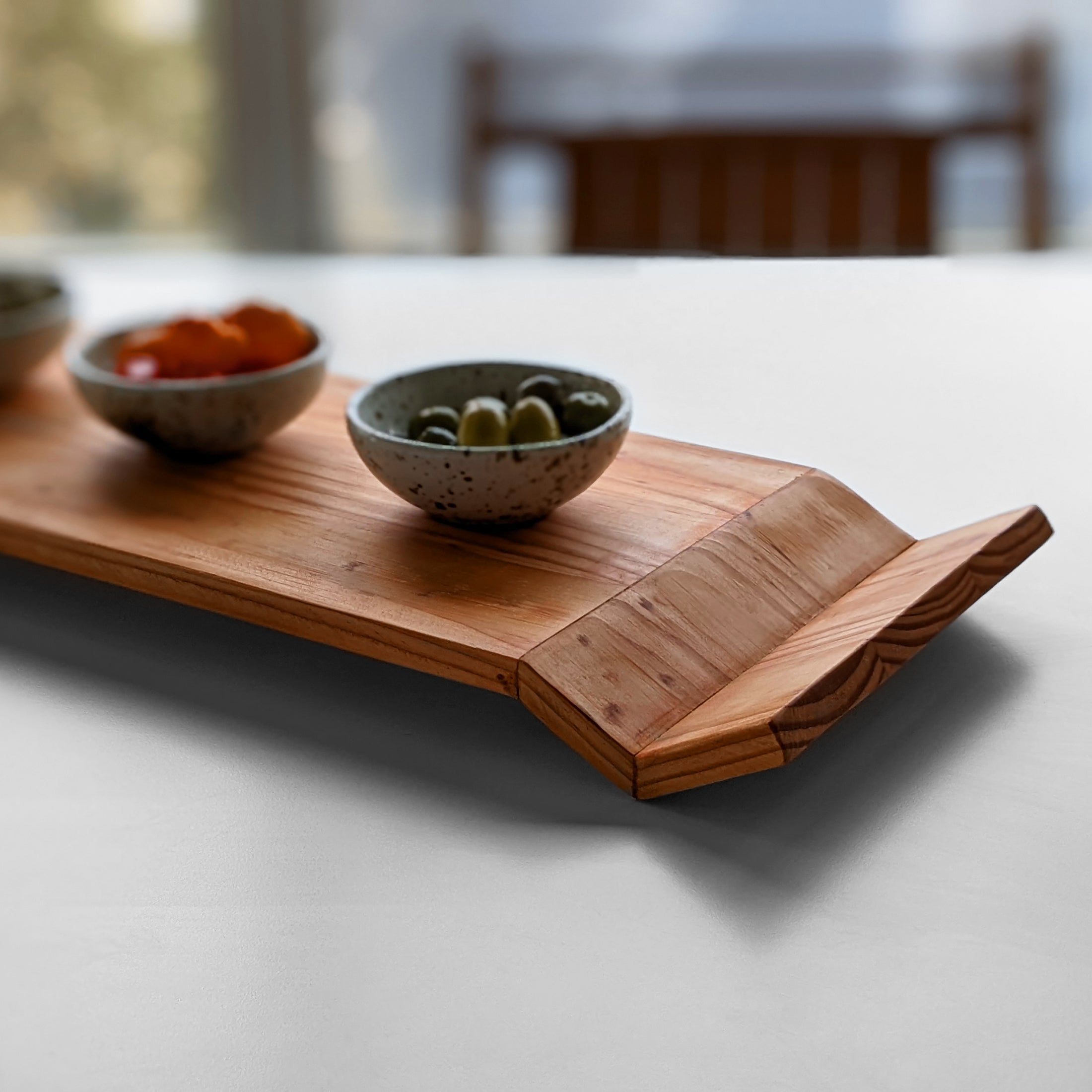 W Tray made of Doug Fir wood with beeswax finish, elegantly designed for serving food.