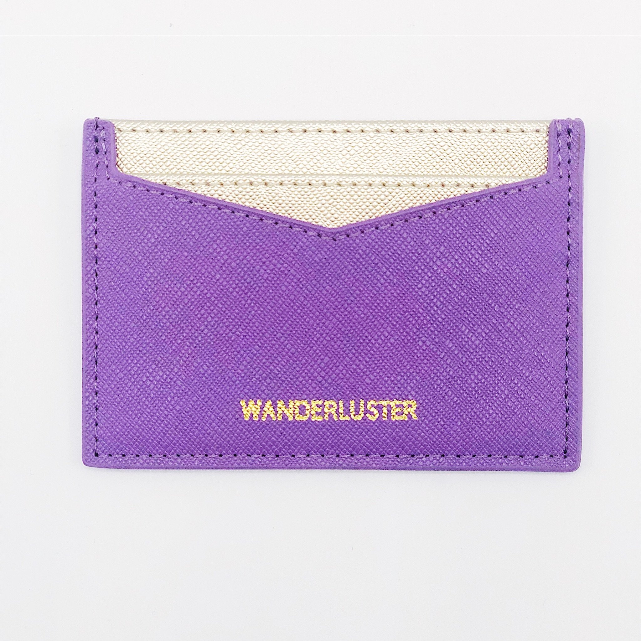 Wanderluster Credit Card Wallet made of saffiano leatherette with embossed gold phrase, featuring four card slots and top bill opening.