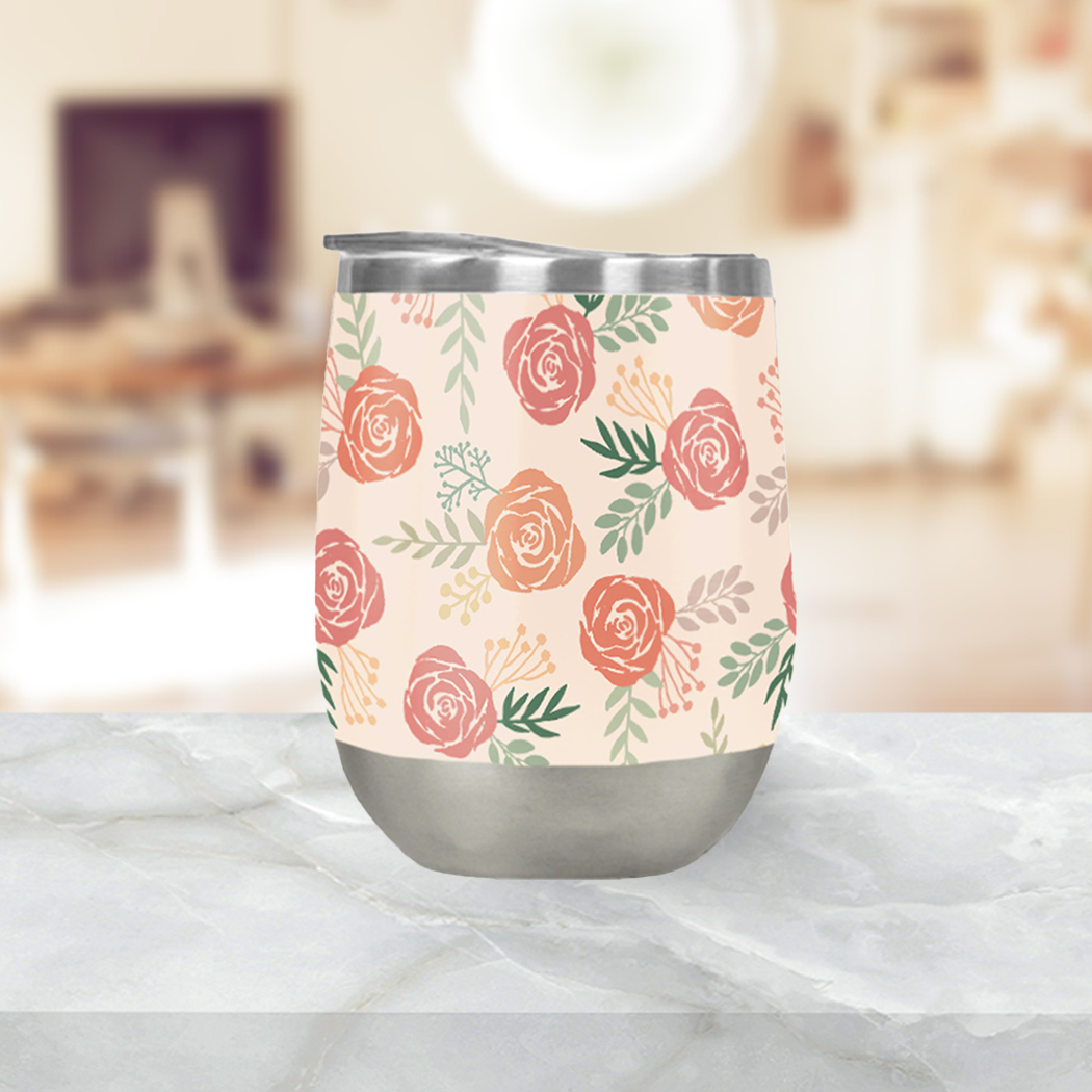 A stylish Warm Floral Wine Tumbler with a vibrant floral design, showcasing its double-wall stainless steel construction and included plastic lid.