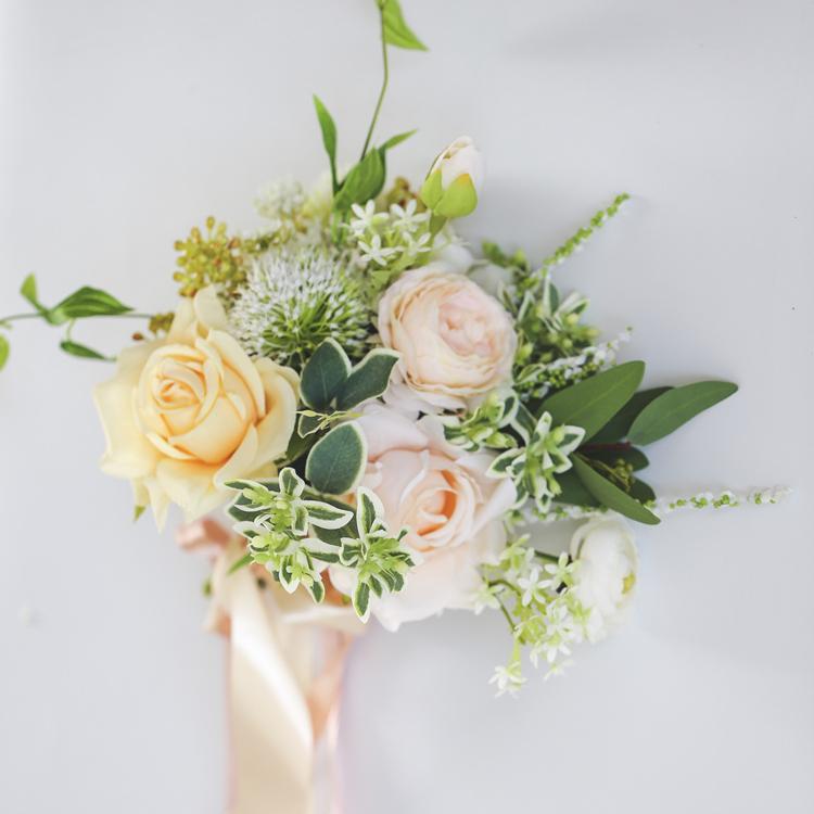 Artificial Wedding Bouquet with Champagne Roses, White Daisies, and Greenery Leaves, beautifully arranged for bridal use.