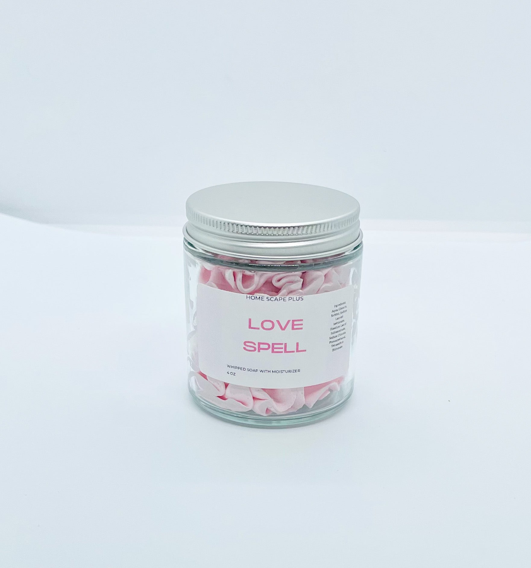 A jar of fluffy whipped bath soap with a creamy texture, perfect for moisturizing and cleansing skin.