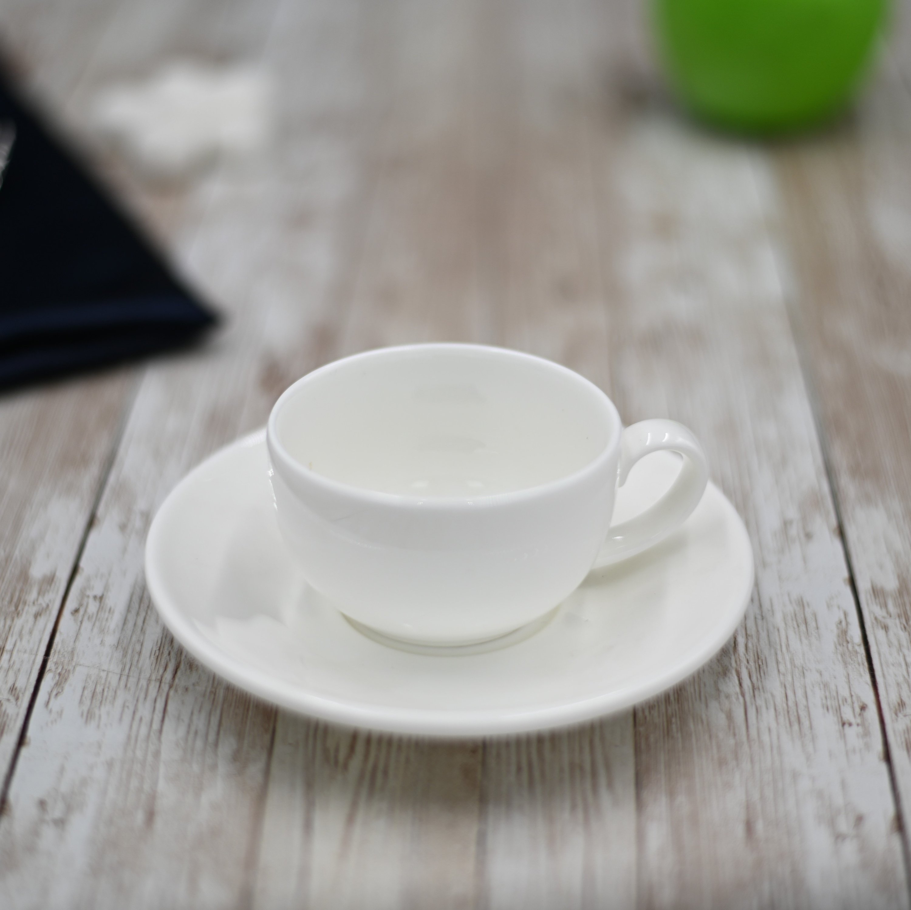 White porcelain coffee cup and saucer set, 3 oz capacity, elegantly designed for dining.