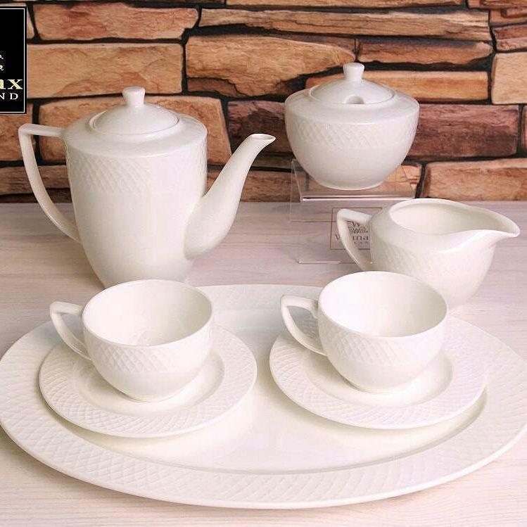 A set of six white porcelain coffee cups and saucers elegantly displayed in a gift box, showcasing their embossed design and rolled rim.