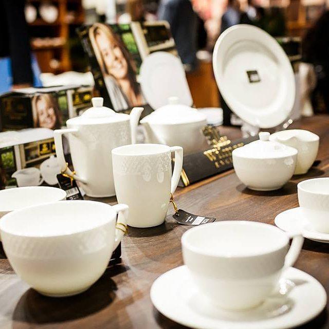 A set of six white porcelain coffee cups and saucers elegantly displayed in a gift box, showcasing their embossed design and rolled rim.