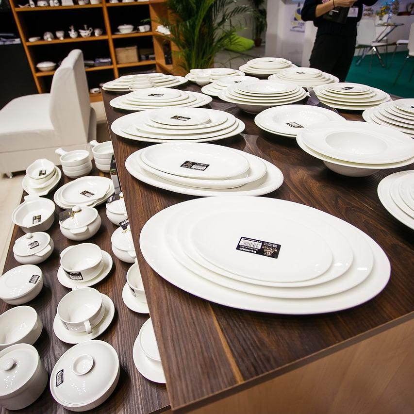 A 6-inch white porcelain bread plate with a rolled rim, showcasing its elegant design and smooth finish.