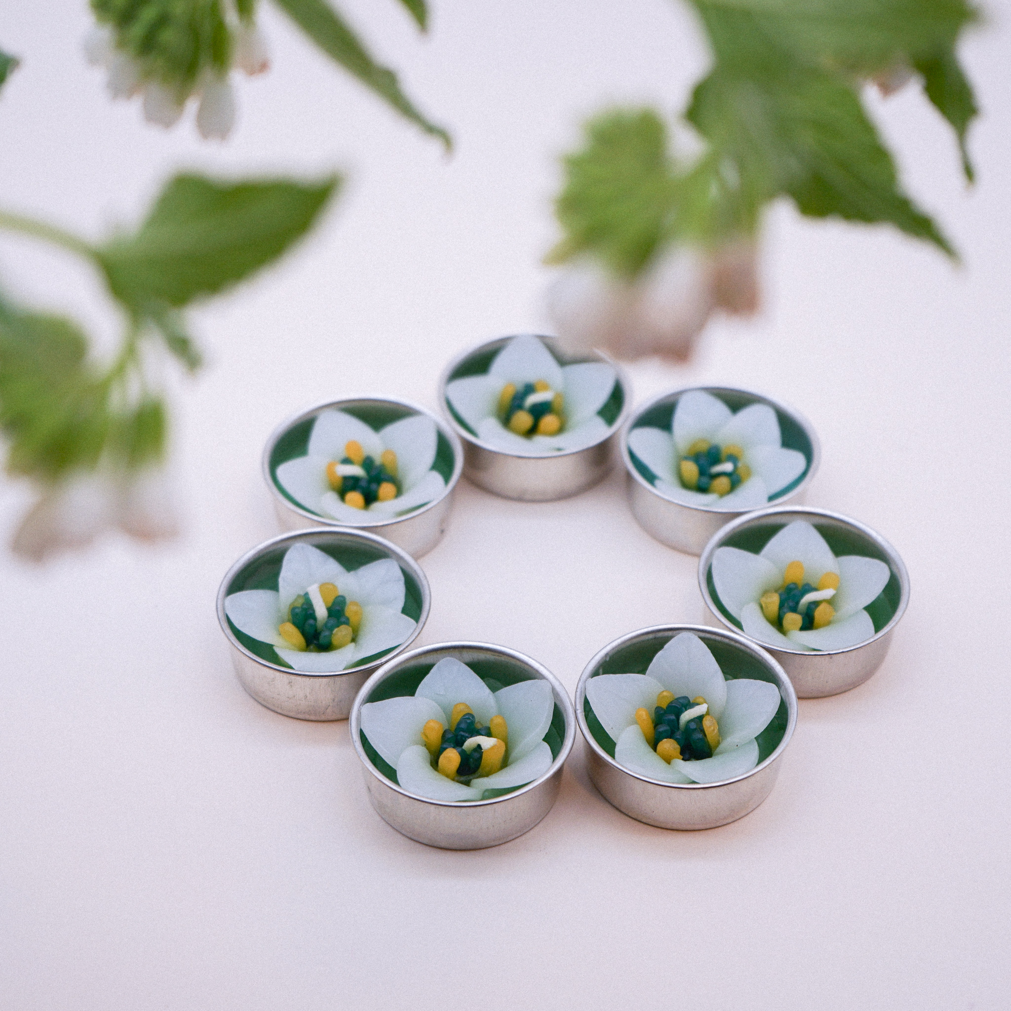 A set of White Campanula Scented Tealights, handmade with Neroli essential oil, displayed elegantly in a tealight holder.