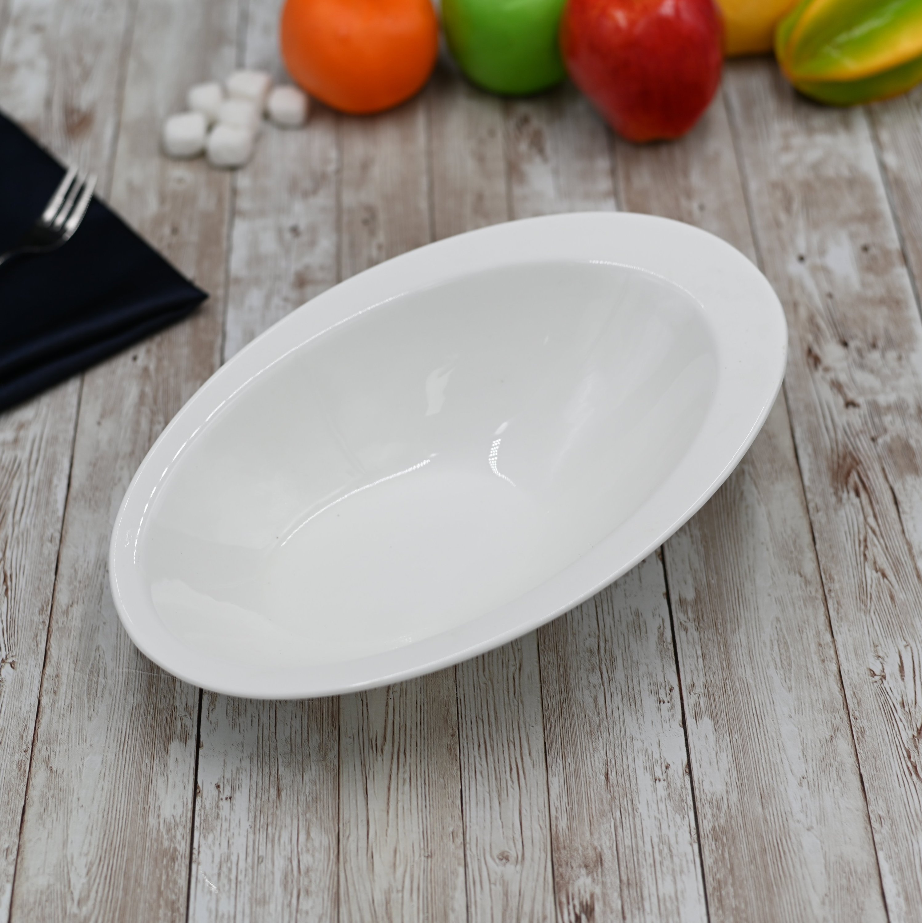 A stylish 11-inch white Caesar salad bowl made of durable porcelain, perfect for serving salads, soups, and pasta.