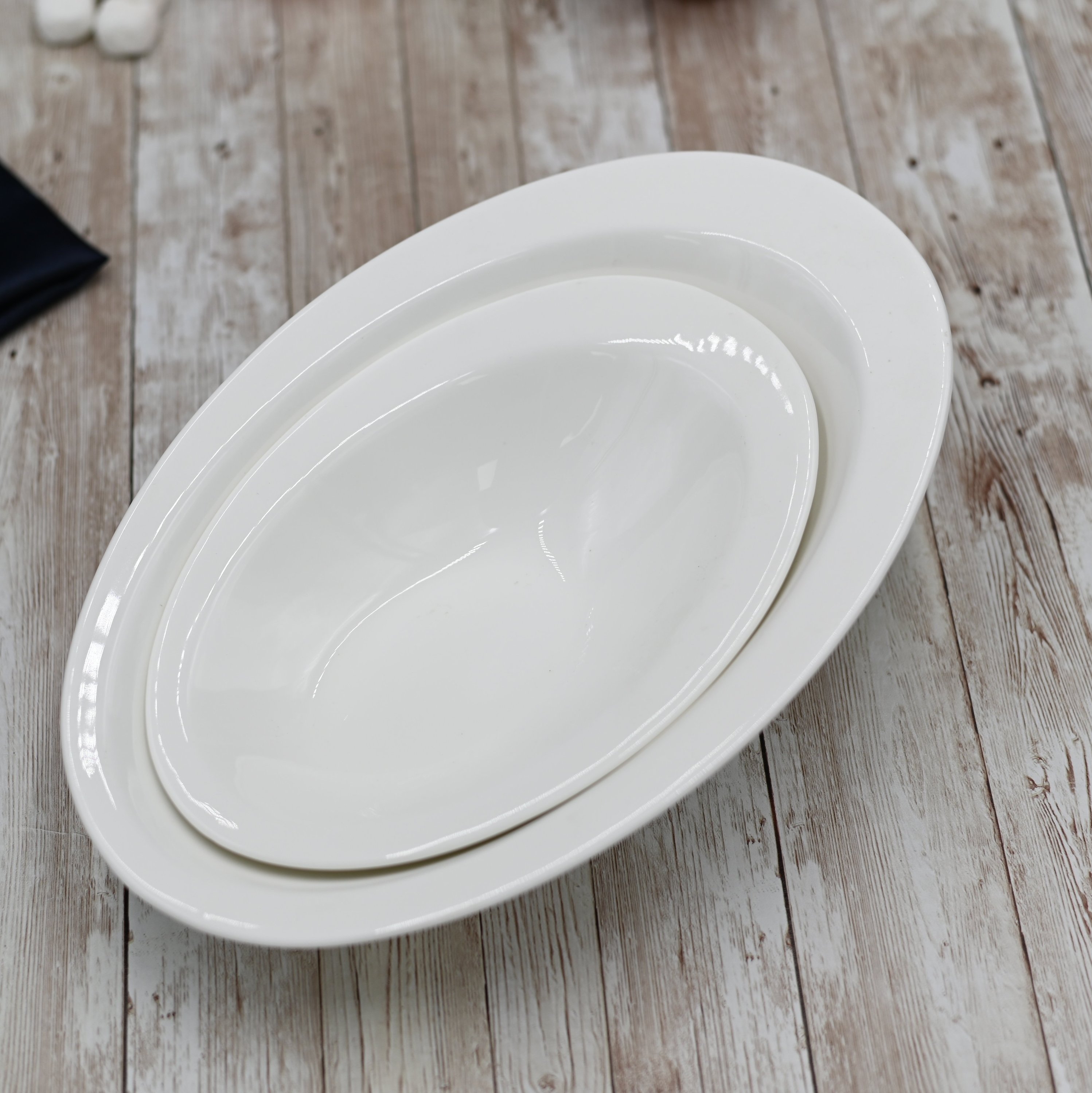 A stylish 11-inch white Caesar salad bowl made of durable porcelain, perfect for serving salads, soups, and pasta.