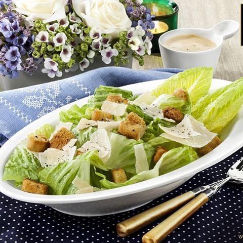 A stylish 11-inch white Caesar salad bowl made of durable porcelain, perfect for serving salads, soups, and pasta.