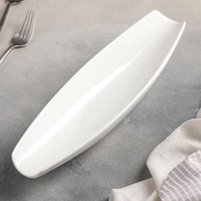 A stylish 13-inch white porcelain celery tray with a rolled rim, perfect for elegant serving.