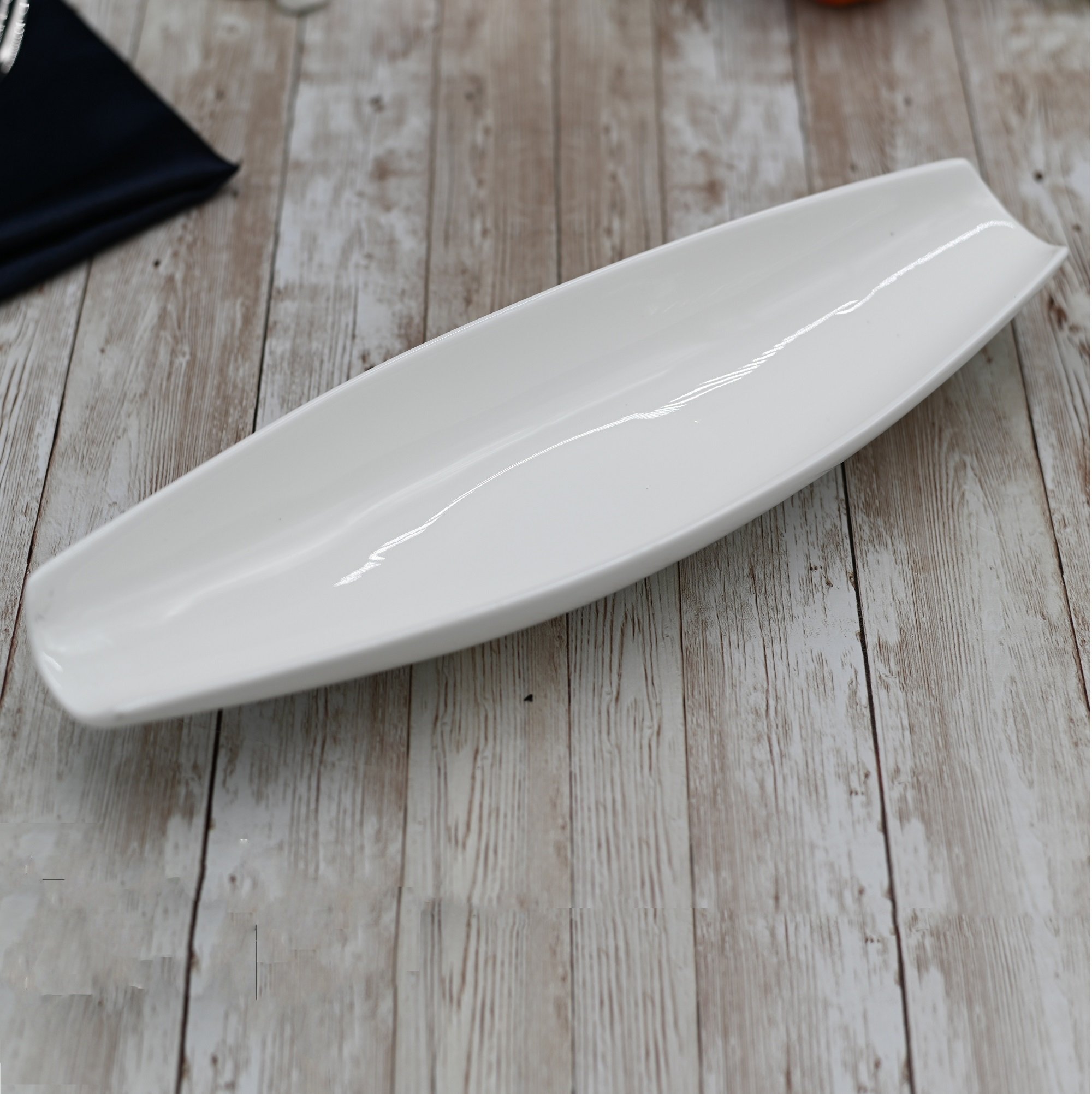 A stylish 13-inch white porcelain celery tray with a rolled rim, perfect for elegant serving.