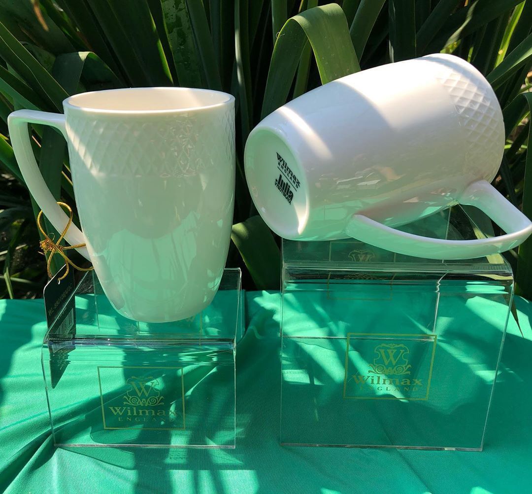 A stylish WILMAX white coffee mug with an embossed design, perfect for serving coffee or tea, showcasing its elegant rolled rim and durable porcelain material.