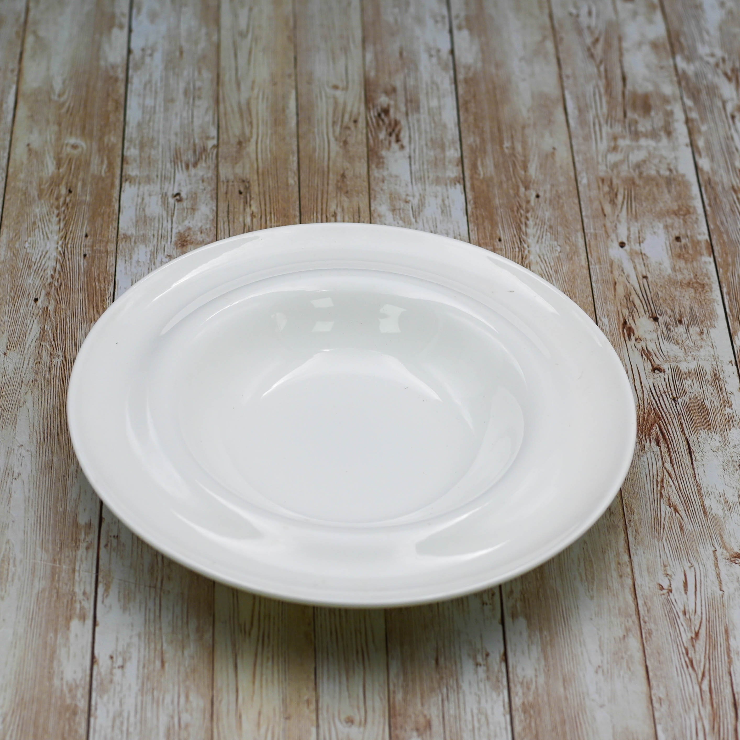 A 10-inch white deep soup plate made of fine porcelain, showcasing its elegant design and rolled rim, perfect for serving soups and stews.