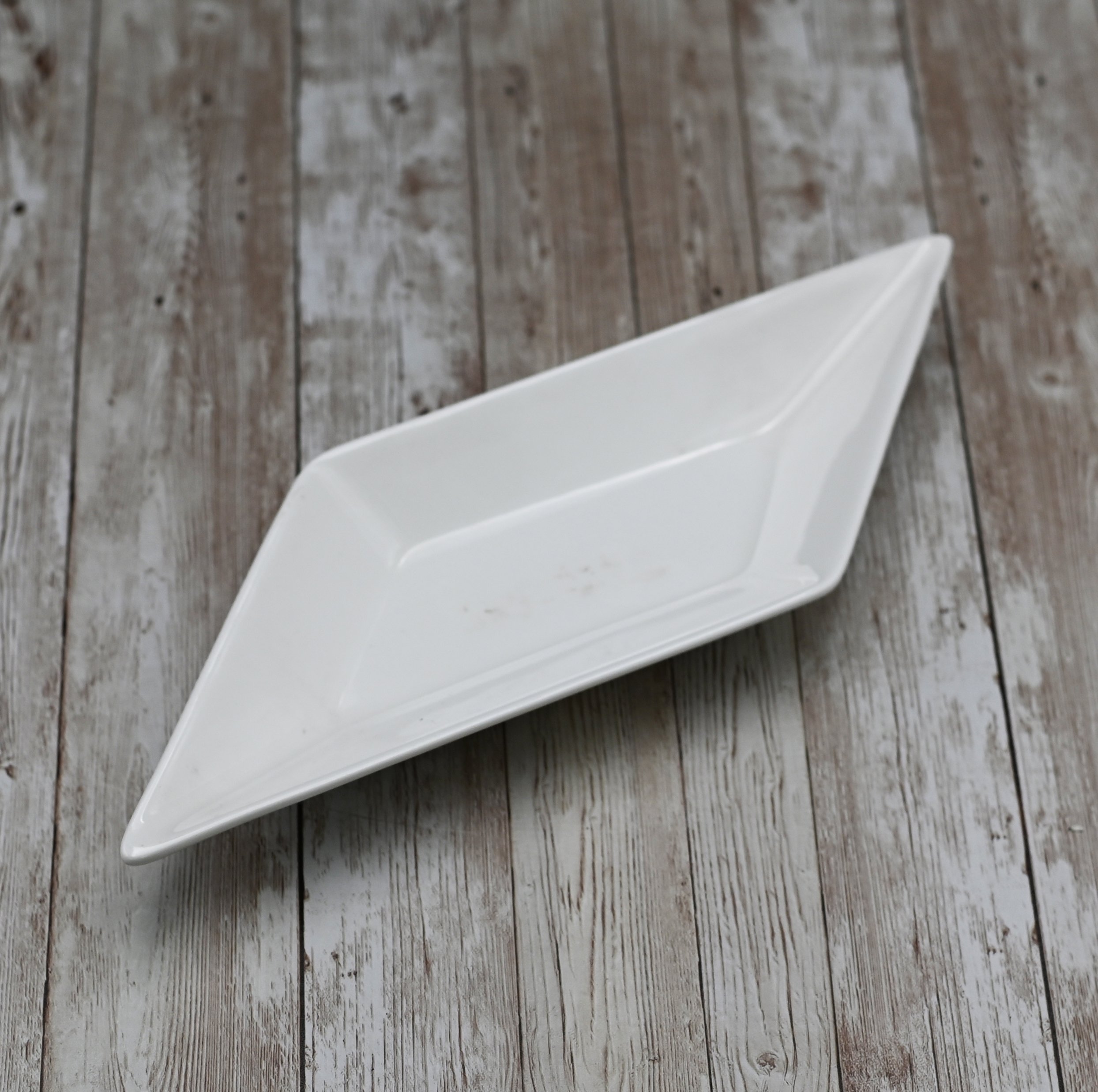 A 12-inch White Diamond Dish made of fine porcelain, featuring a unique diamond shape and rolled rim, perfect for elegant dining.