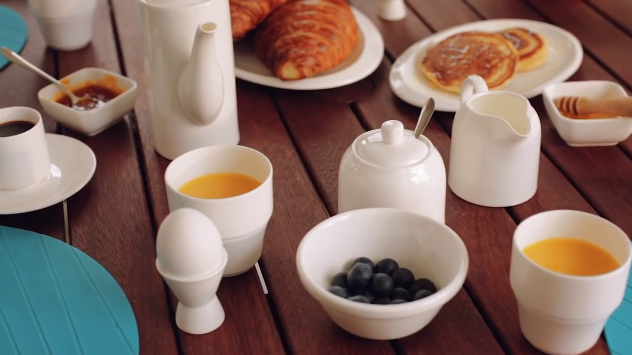 A stylish 4-inch white serving dish with an angled round shape and rolled rim, made from fine vitrified porcelain.