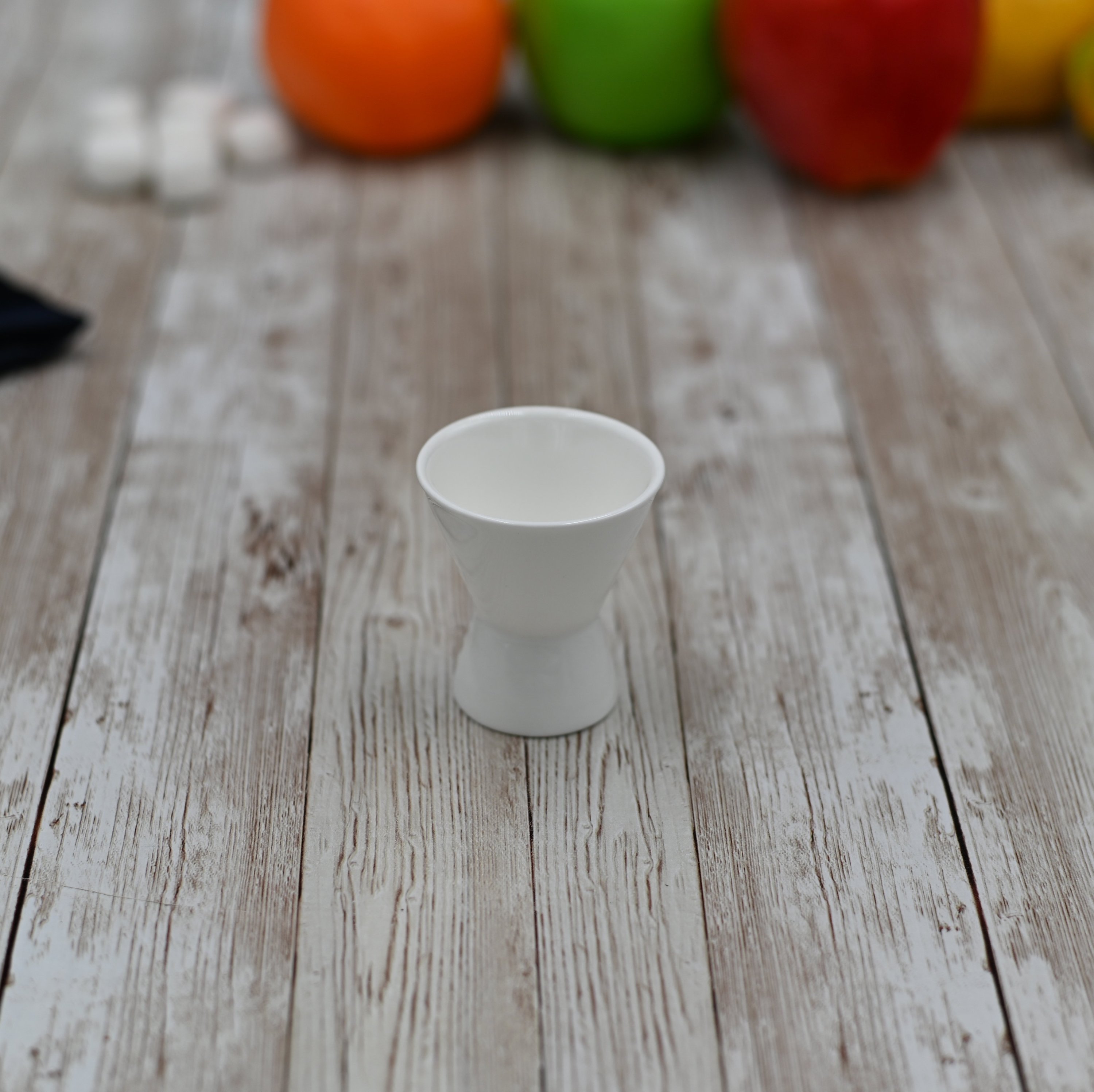 Elegant white porcelain egg cup designed for serving soft or hard boiled eggs, featuring a round shape and simple lines.