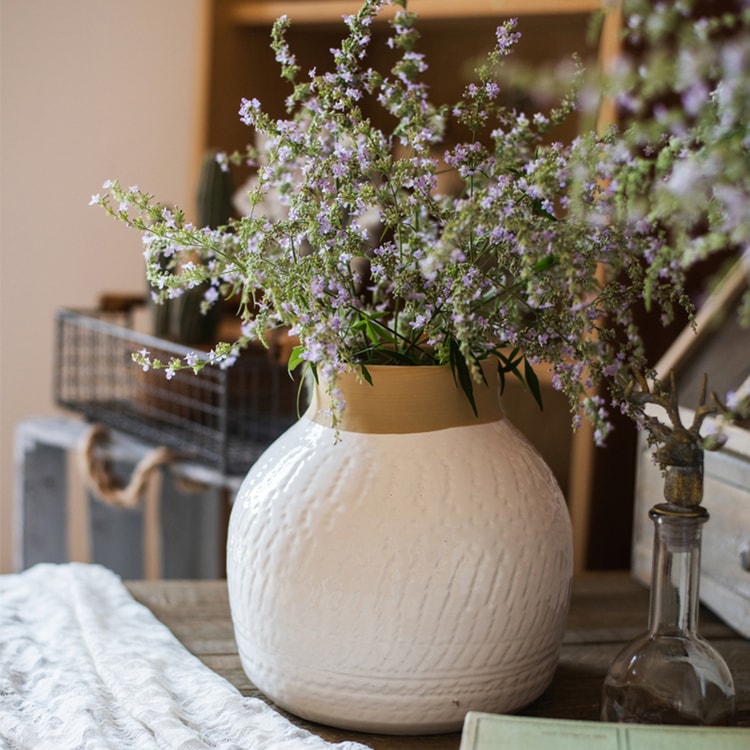 A beautifully crafted white glazed ceramic flower vase, showcasing a sleek design and handmade artistry, perfect for floral arrangements.