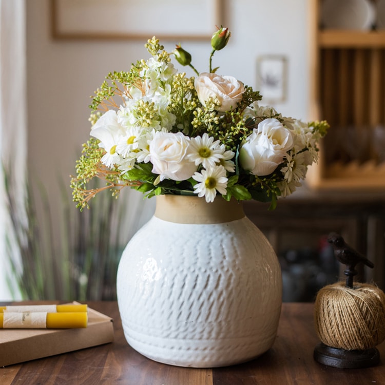 A beautifully crafted white glazed ceramic flower vase, showcasing a sleek design and handmade artistry, perfect for floral arrangements.