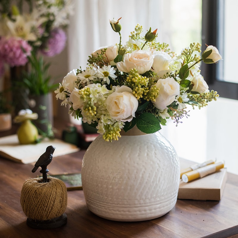 A beautifully crafted white glazed ceramic flower vase, showcasing a sleek design and handmade artistry, perfect for floral arrangements.