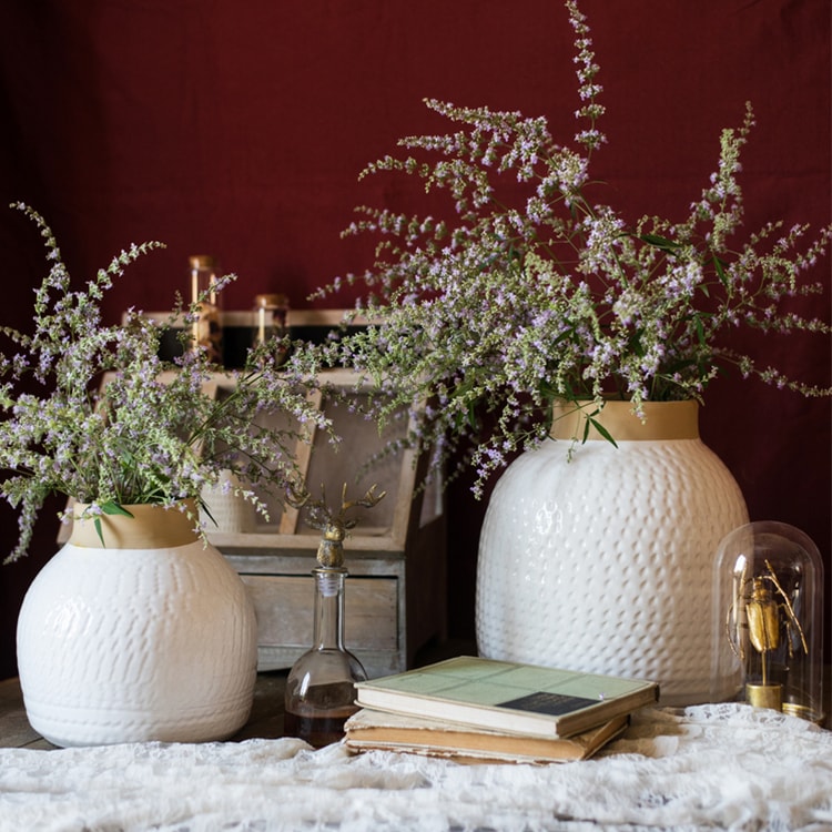 A beautifully crafted white glazed ceramic flower vase, showcasing a sleek design and handmade artistry, perfect for floral arrangements.