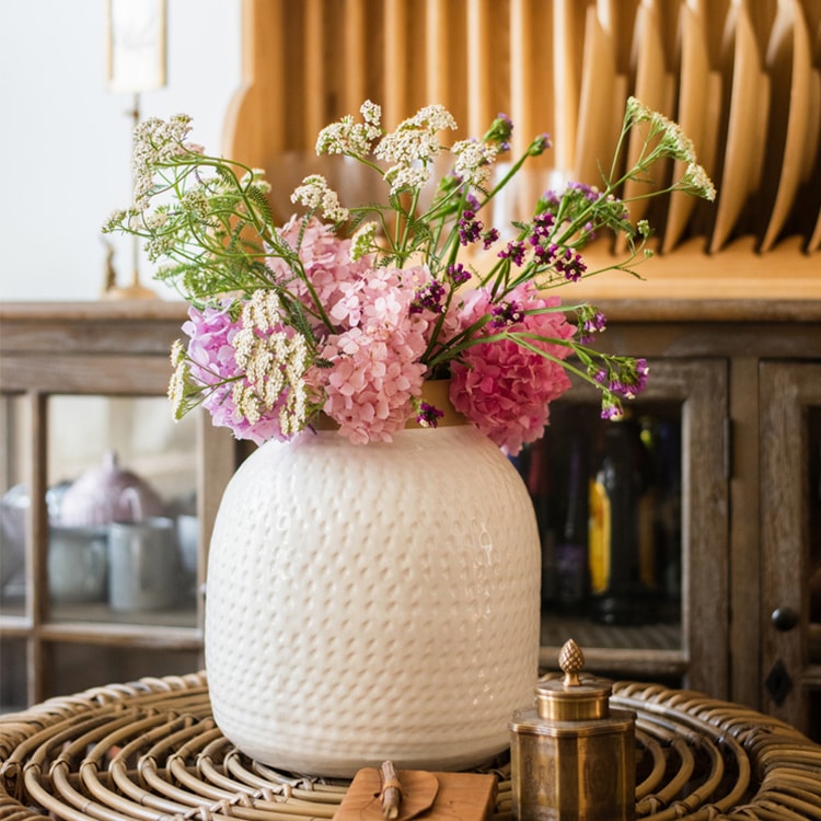 A beautifully crafted white glazed ceramic flower vase, showcasing a sleek design and handmade artistry, perfect for floral arrangements.