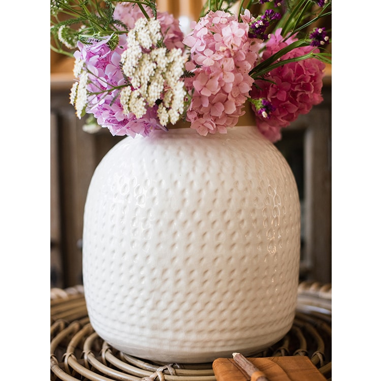 A beautifully crafted white glazed ceramic flower vase, showcasing a sleek design and handmade artistry, perfect for floral arrangements.