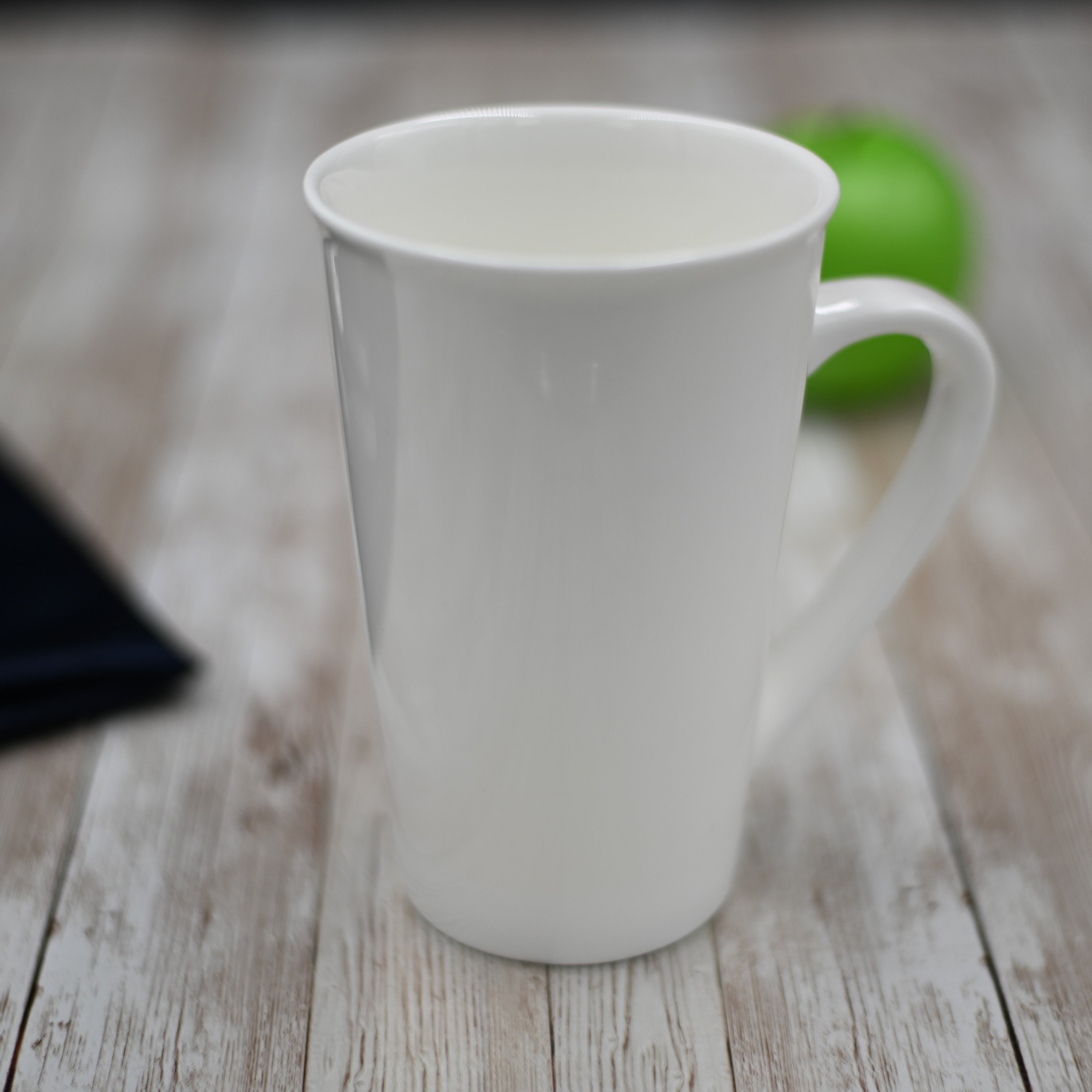 Elegant WILMAX white porcelain mug, 19 oz capacity, perfect for coffee or tea, showcasing its stylish design and durability.