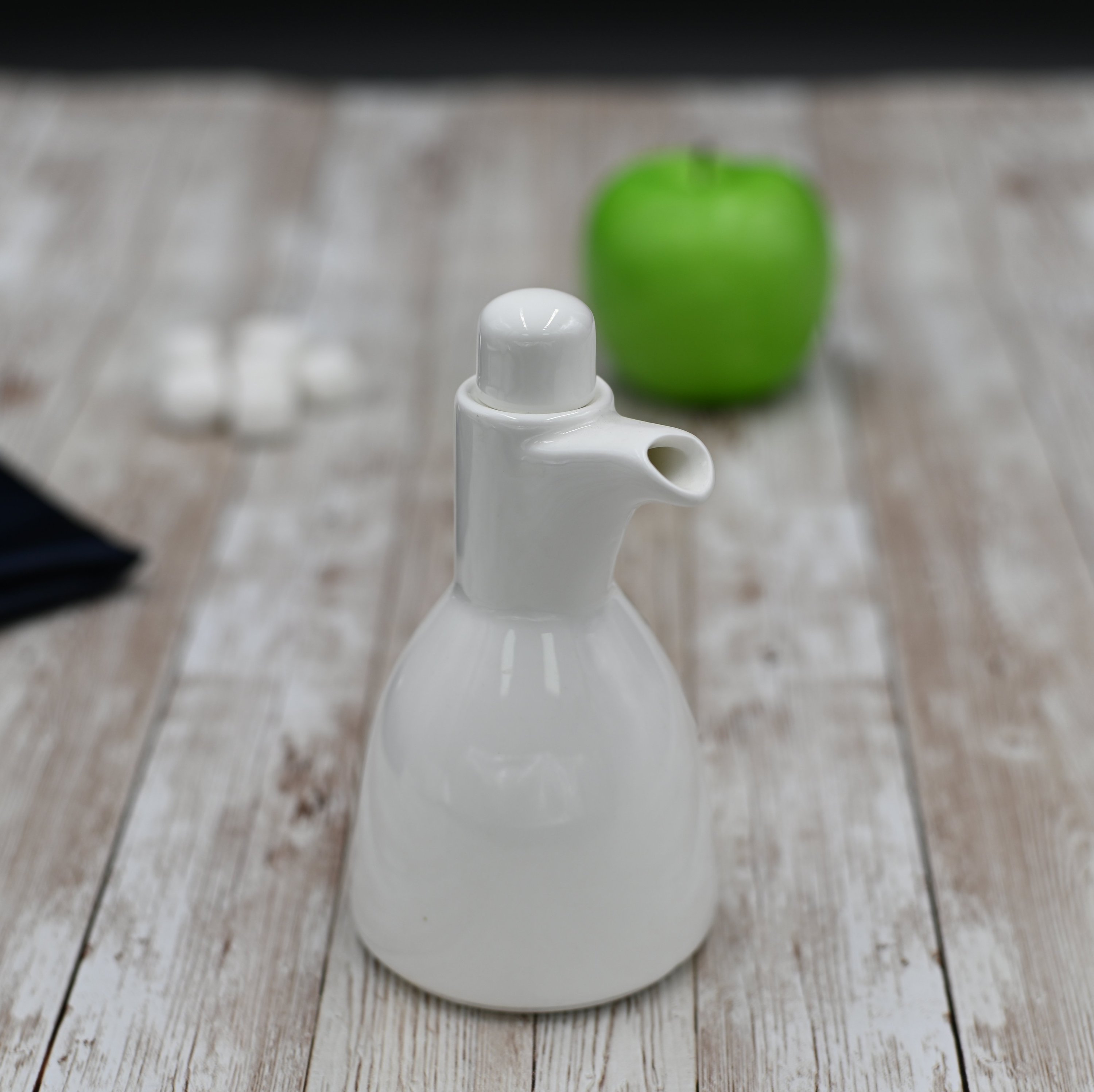 Elegant white porcelain oil and vinegar bottle, 8 oz capacity, perfect for stylish table settings.