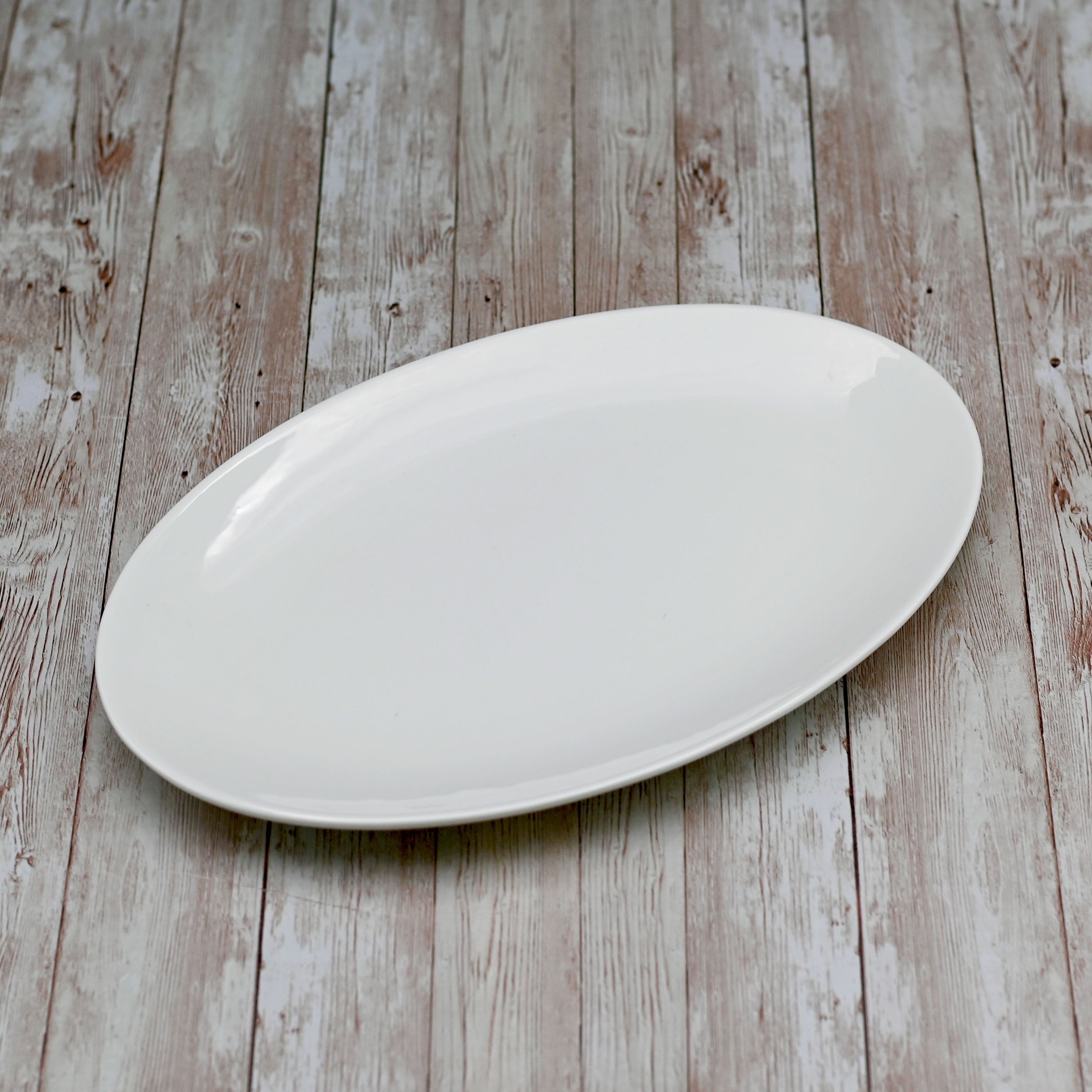 Wilmax 14-inch white oval platter showcasing elegant design, perfect for serving various dishes.