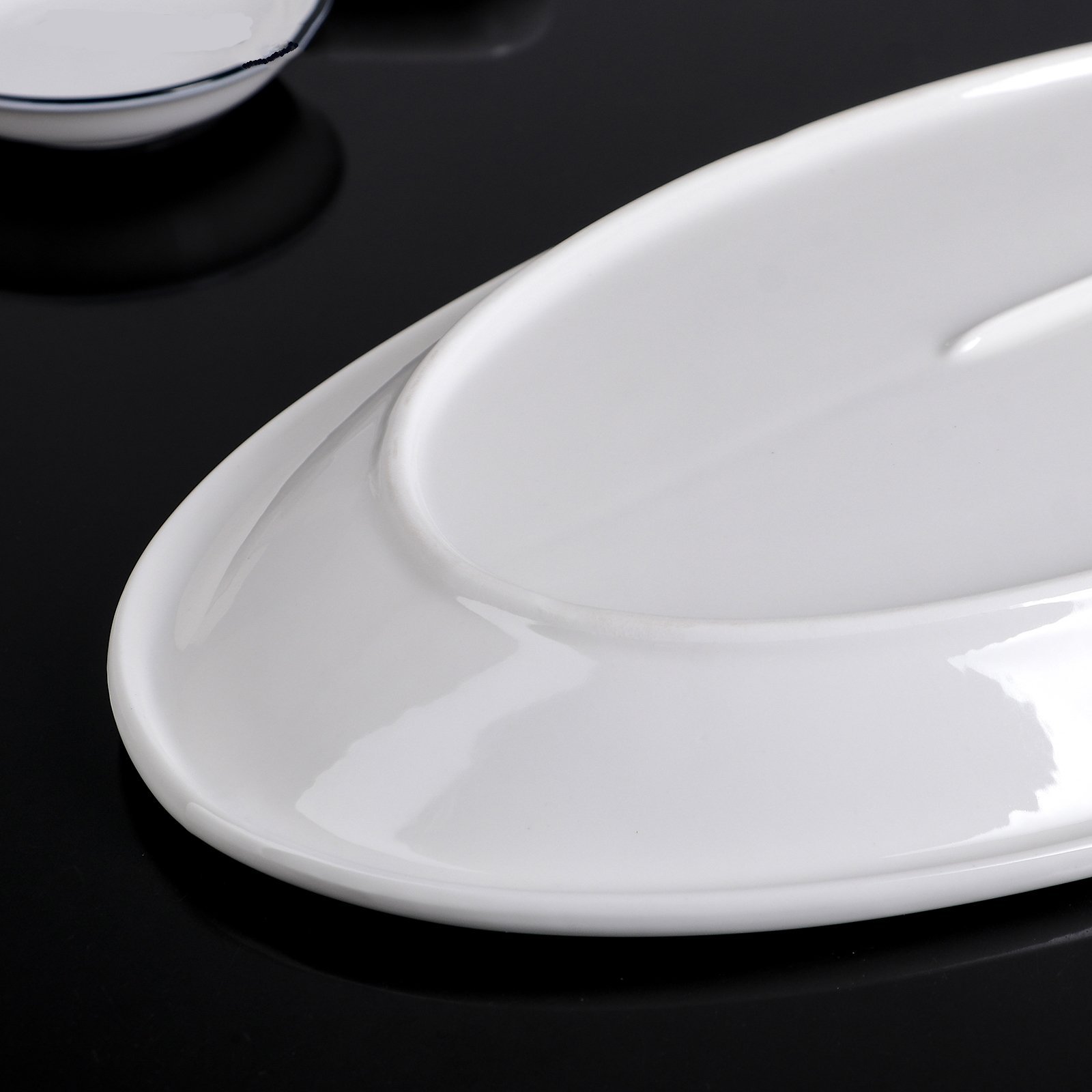 Elegant Wilmax White Oval Plate, 14.5 inches, perfect for serving various dishes.