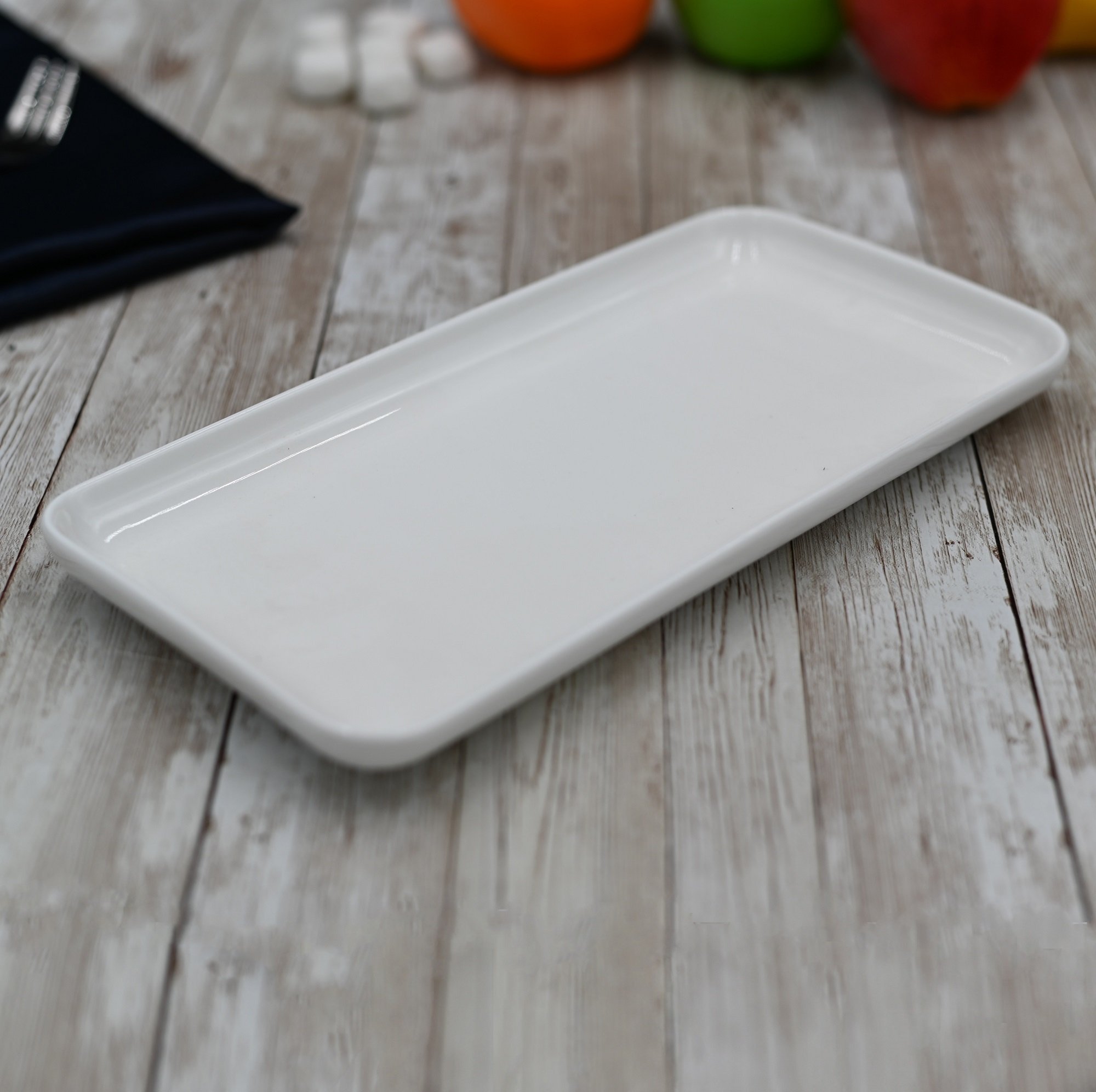 A stylish white rectangular dish measuring 10 inches by 5 inches, made of fine porcelain, ideal for serving various dishes.