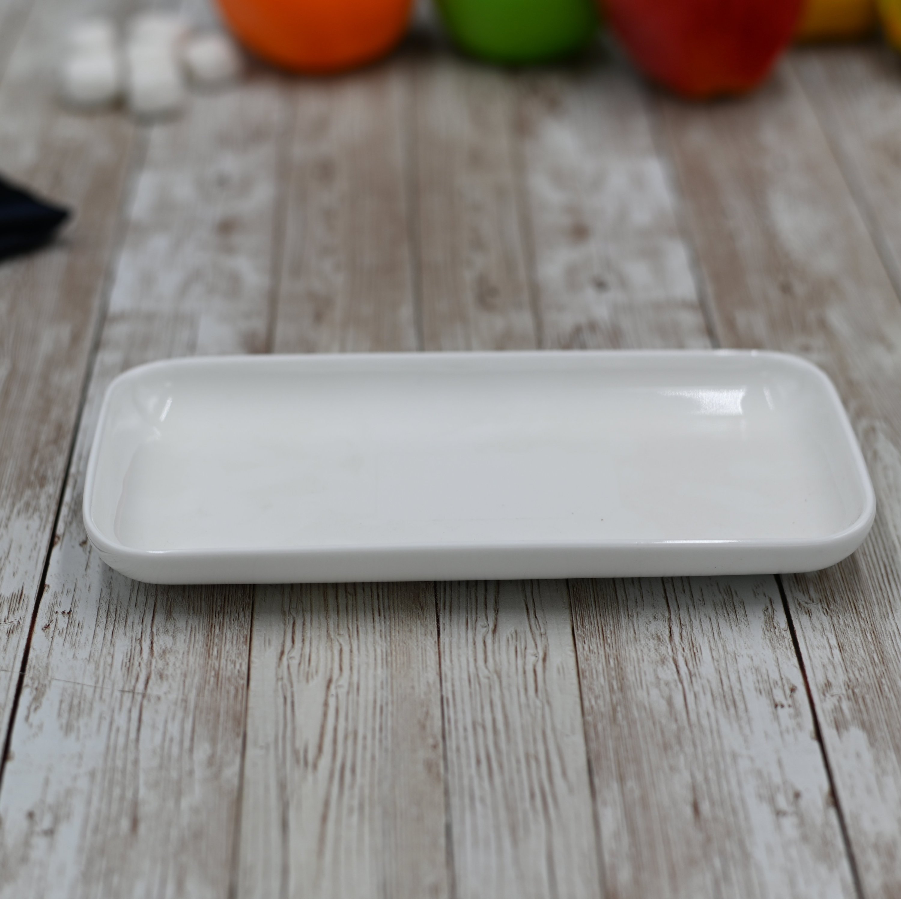 A stylish white rectangular dish measuring 7.5 inches by 3.75 inches, perfect for modern dining and serving.