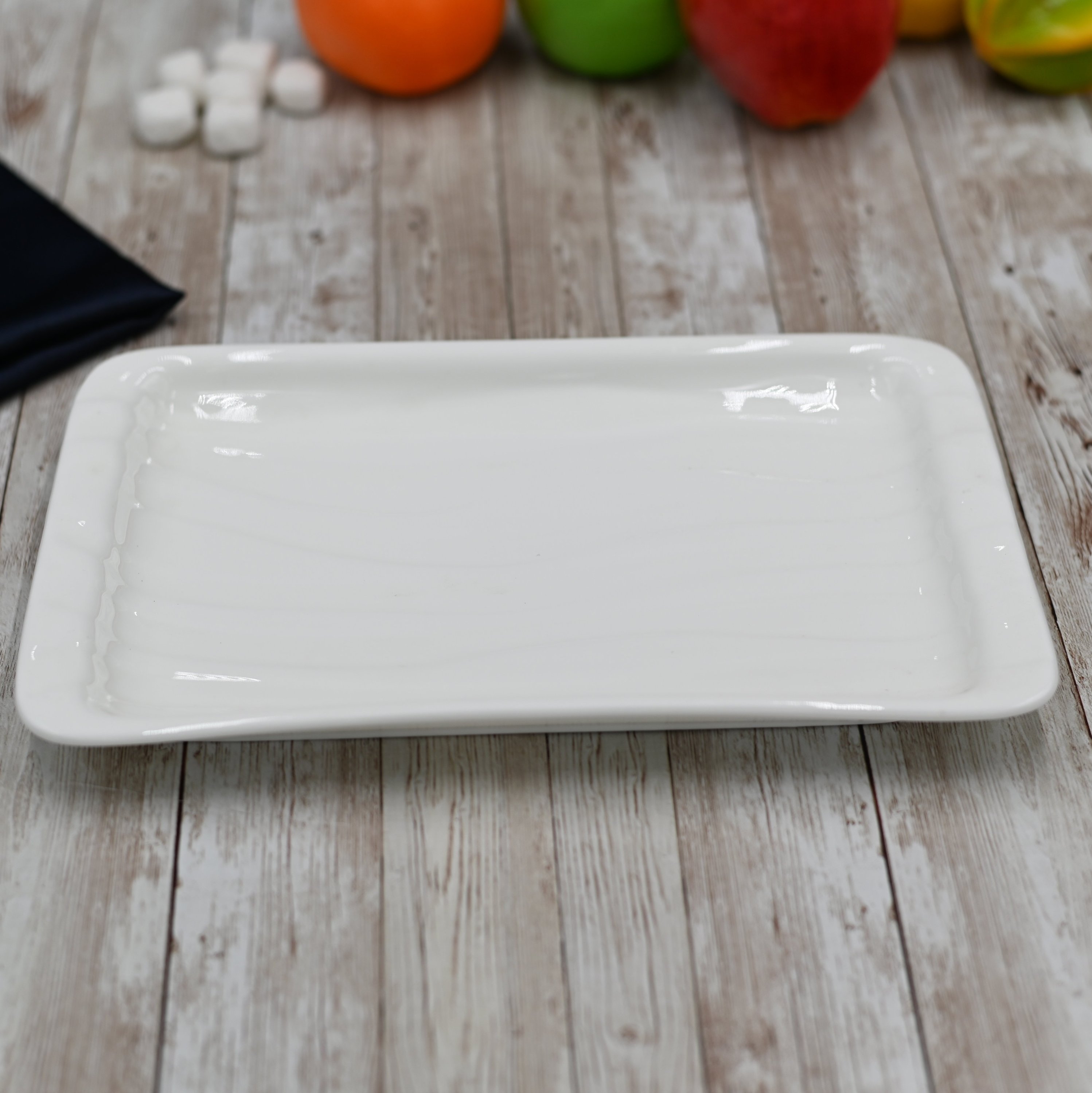 Elegant white rectangular Japanese style dish, perfect for serving sushi and other delicacies, showcasing a unique wave texture.